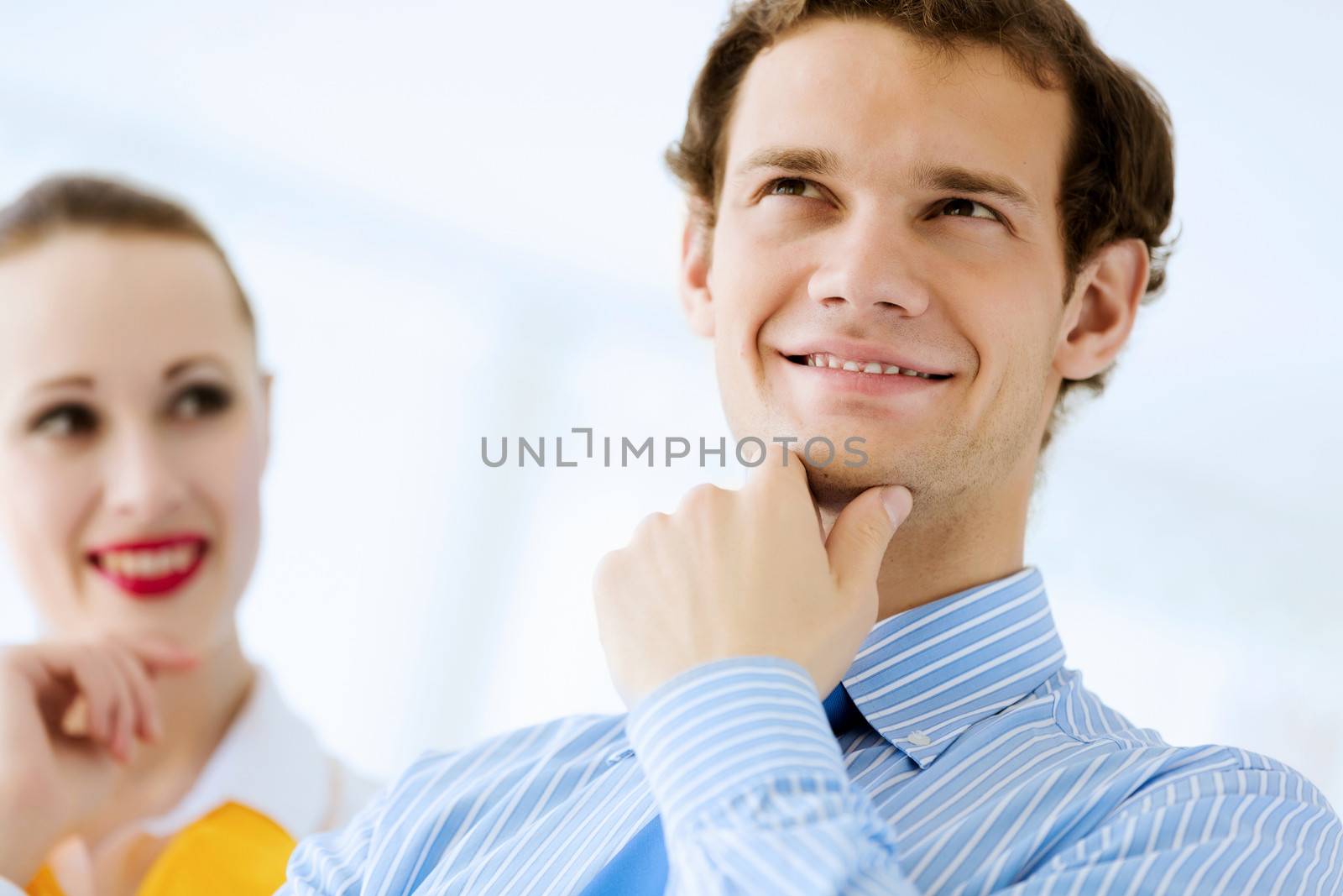 Image of businessman and businesswoman smiling joyfully