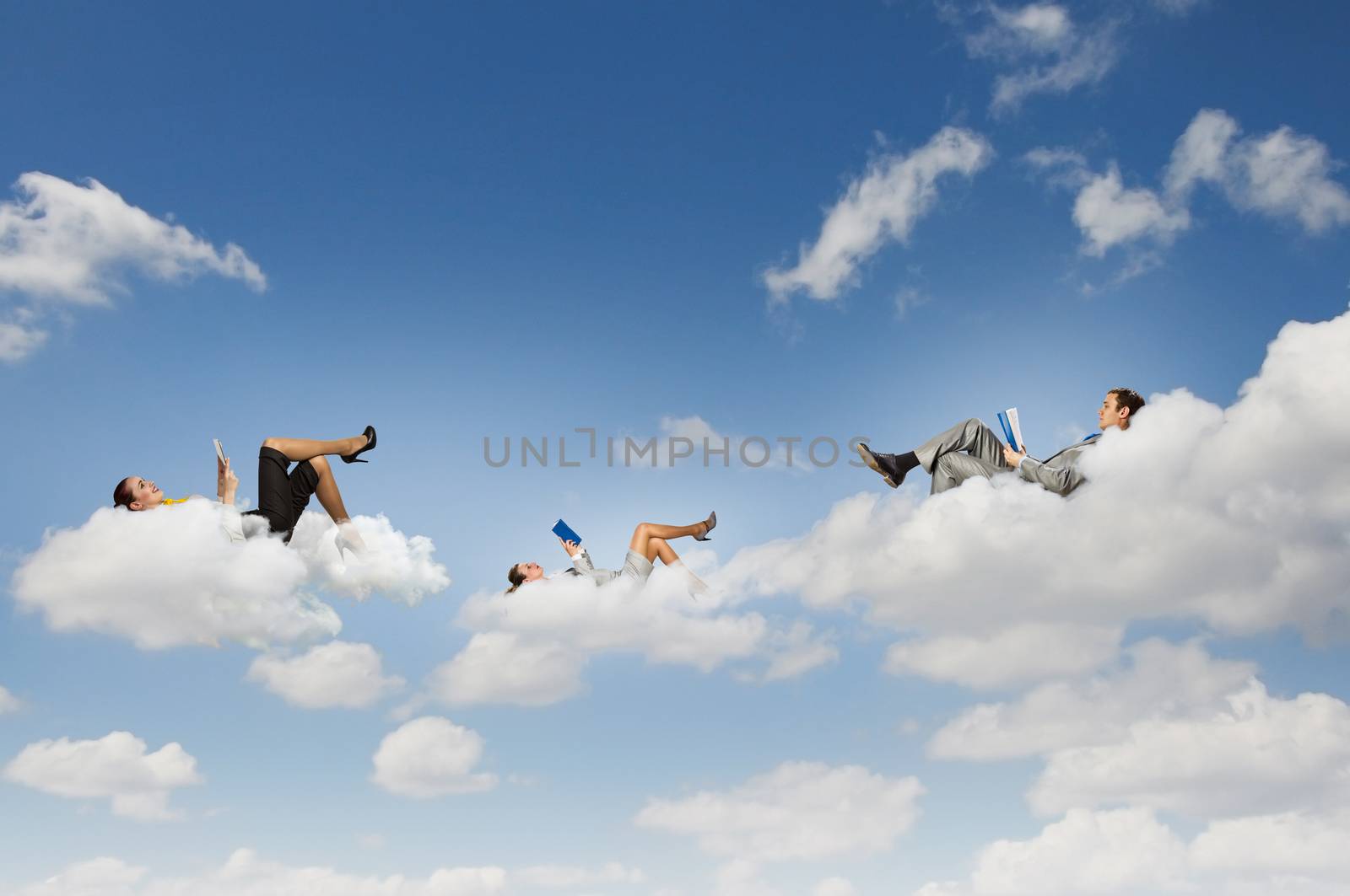 Image of businesspeople lying on clouds with tablet pc