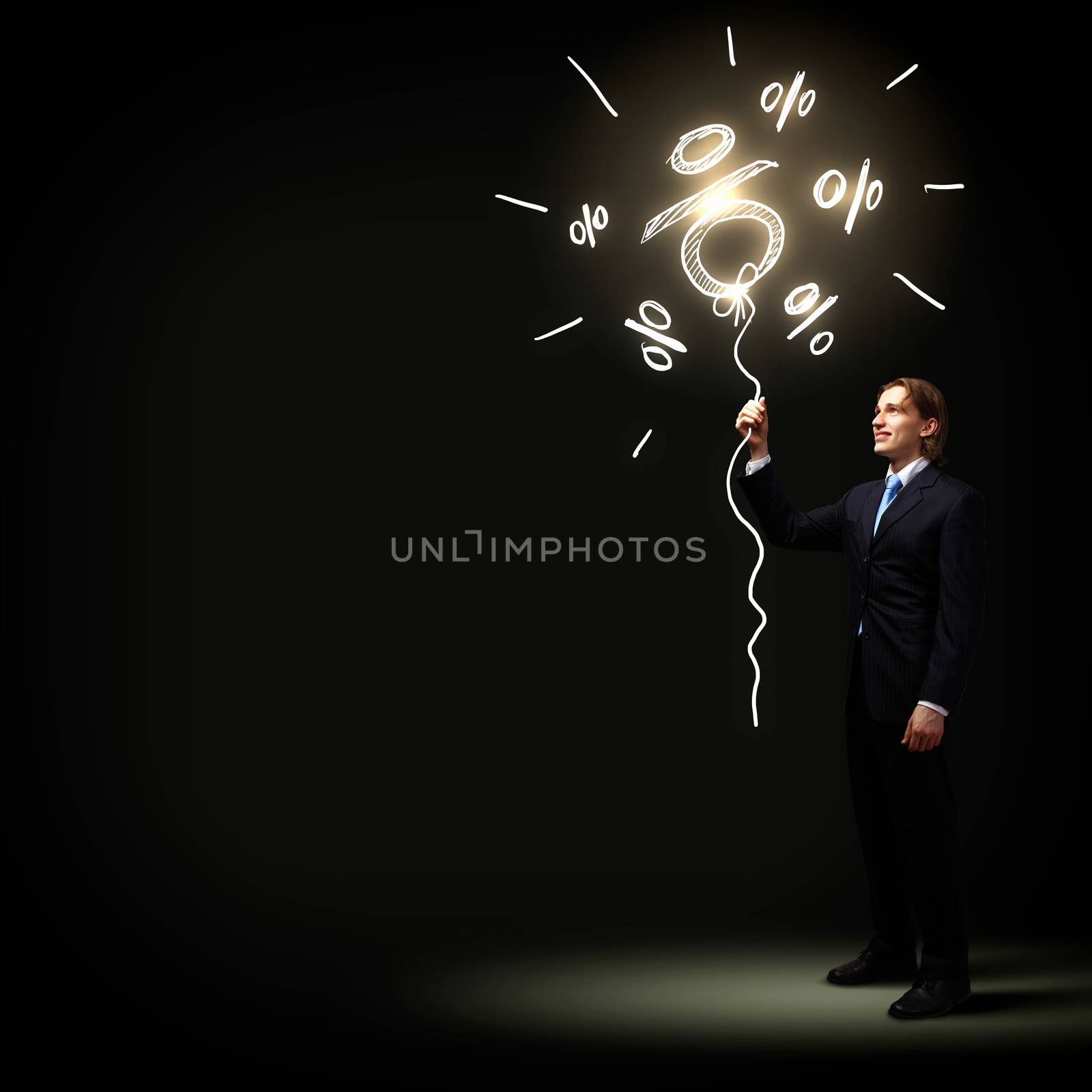 Image of businessman in black suit against dark background