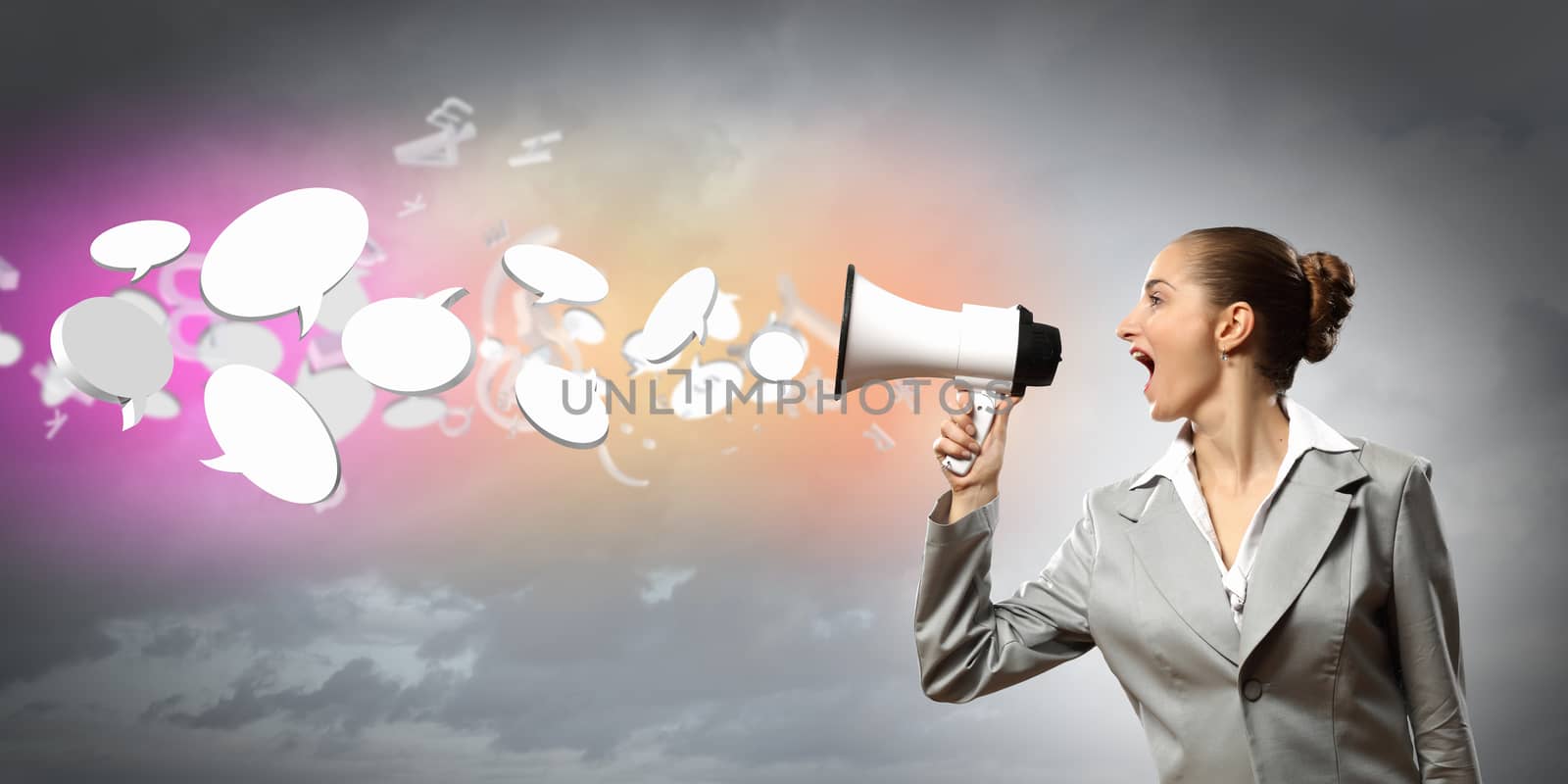 businesswoman in grey suit screaming into megaphone