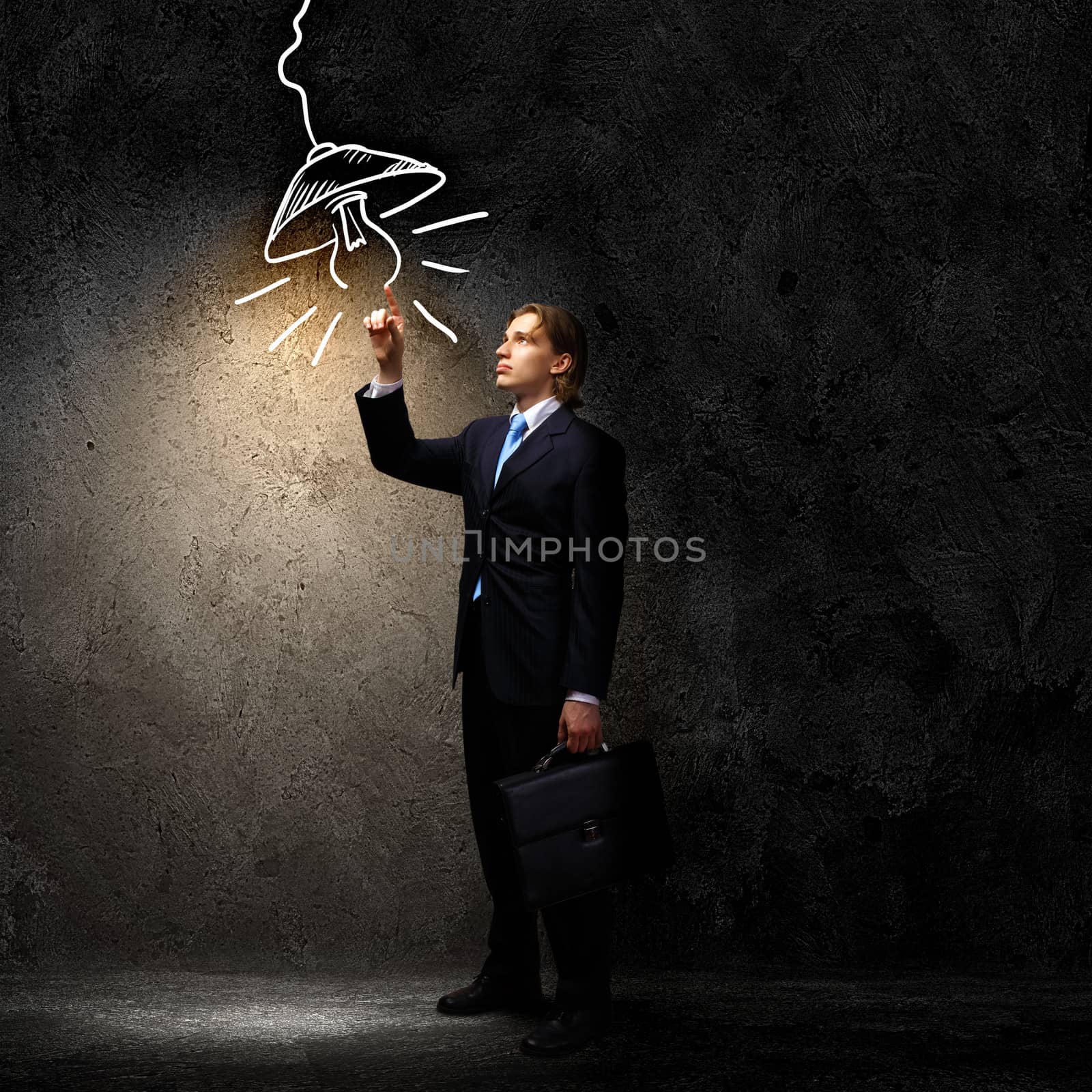 Image of businessman in black suit against dark background