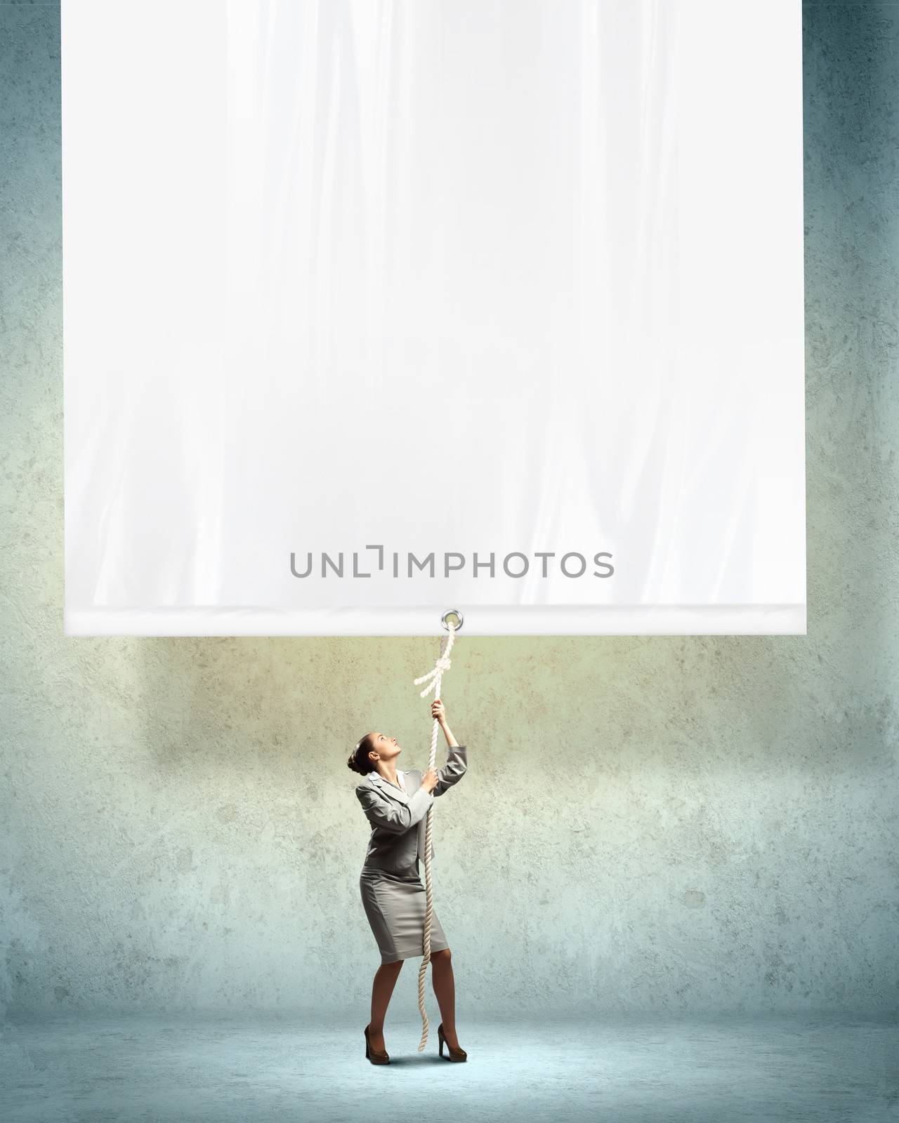 Businesswoman pulling blank banner by sergey_nivens