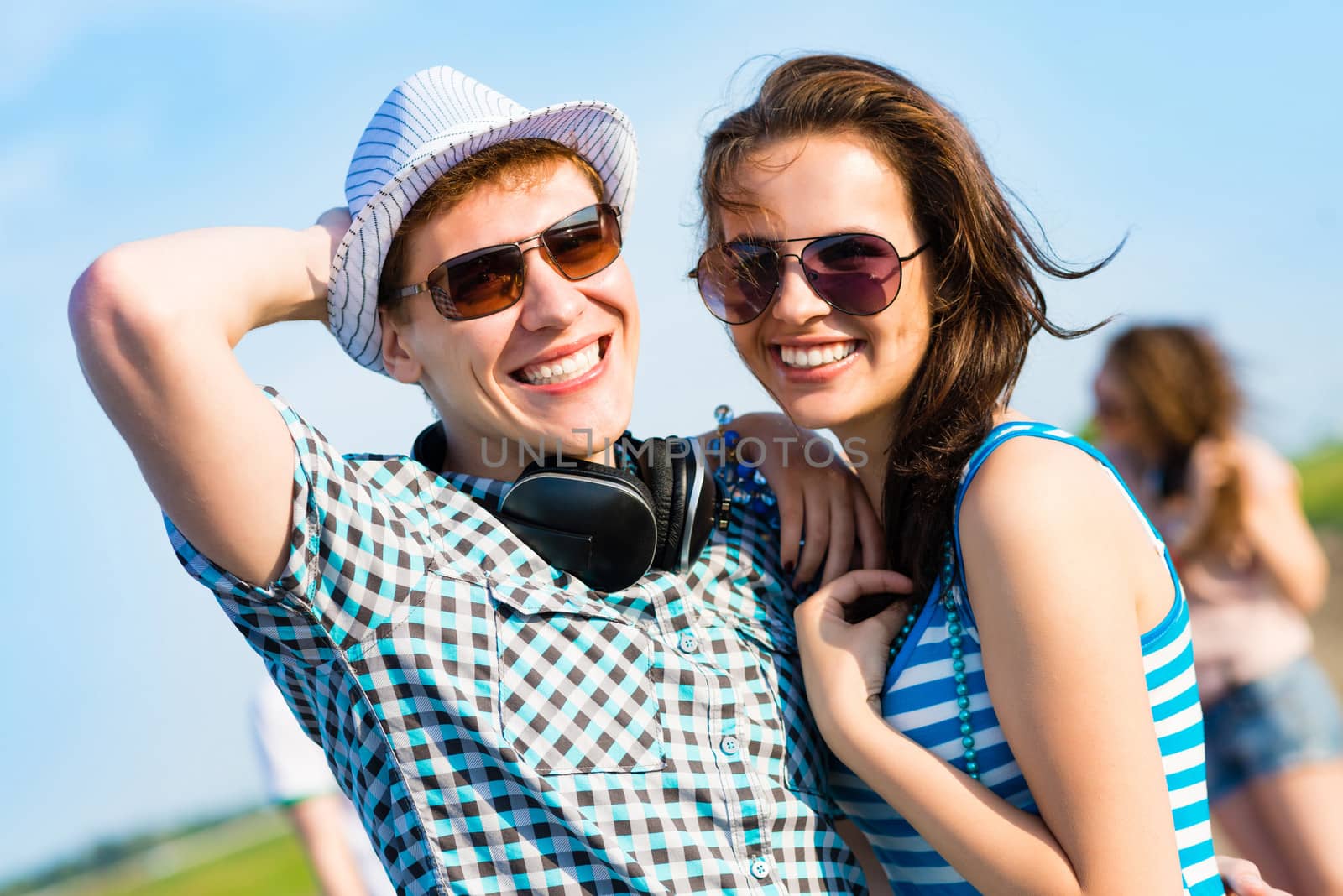 young couple standing on the road, having fun with friends