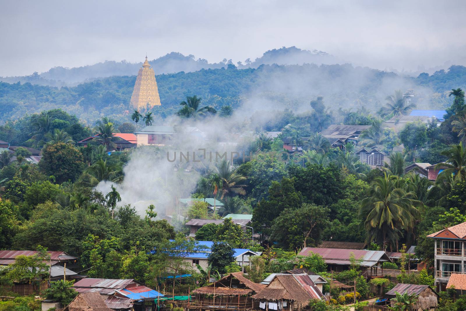 Golden pagpda and the morning mist at sangklaburi, thailand