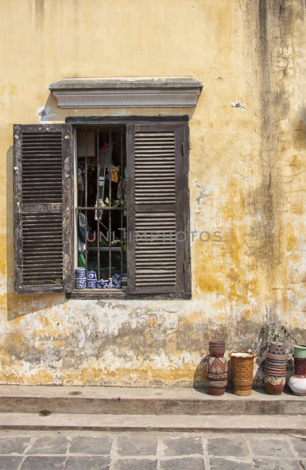 Window in old house and pots in Hoi An, Vietnam