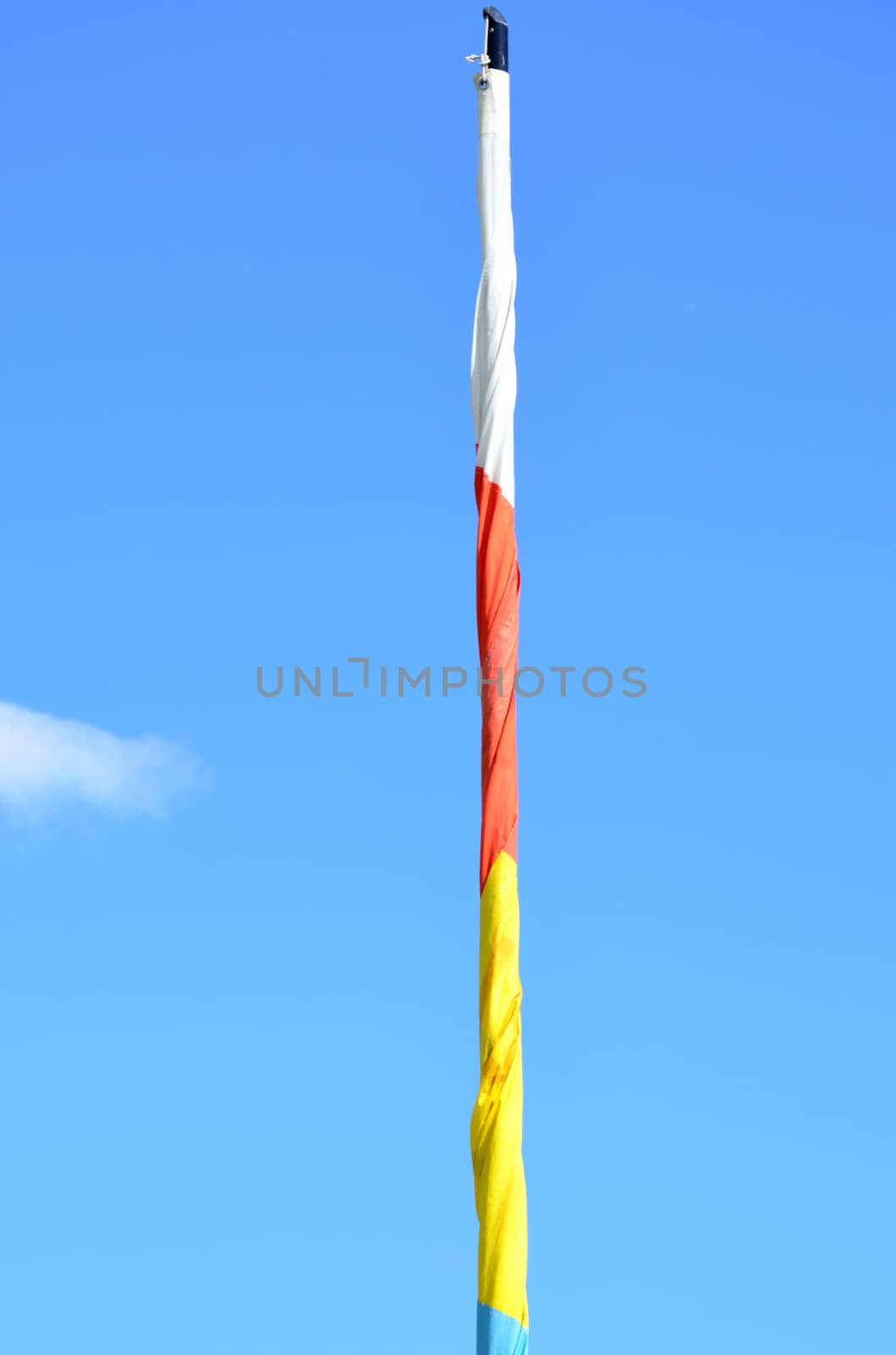 White red and yellow rolled up flag  