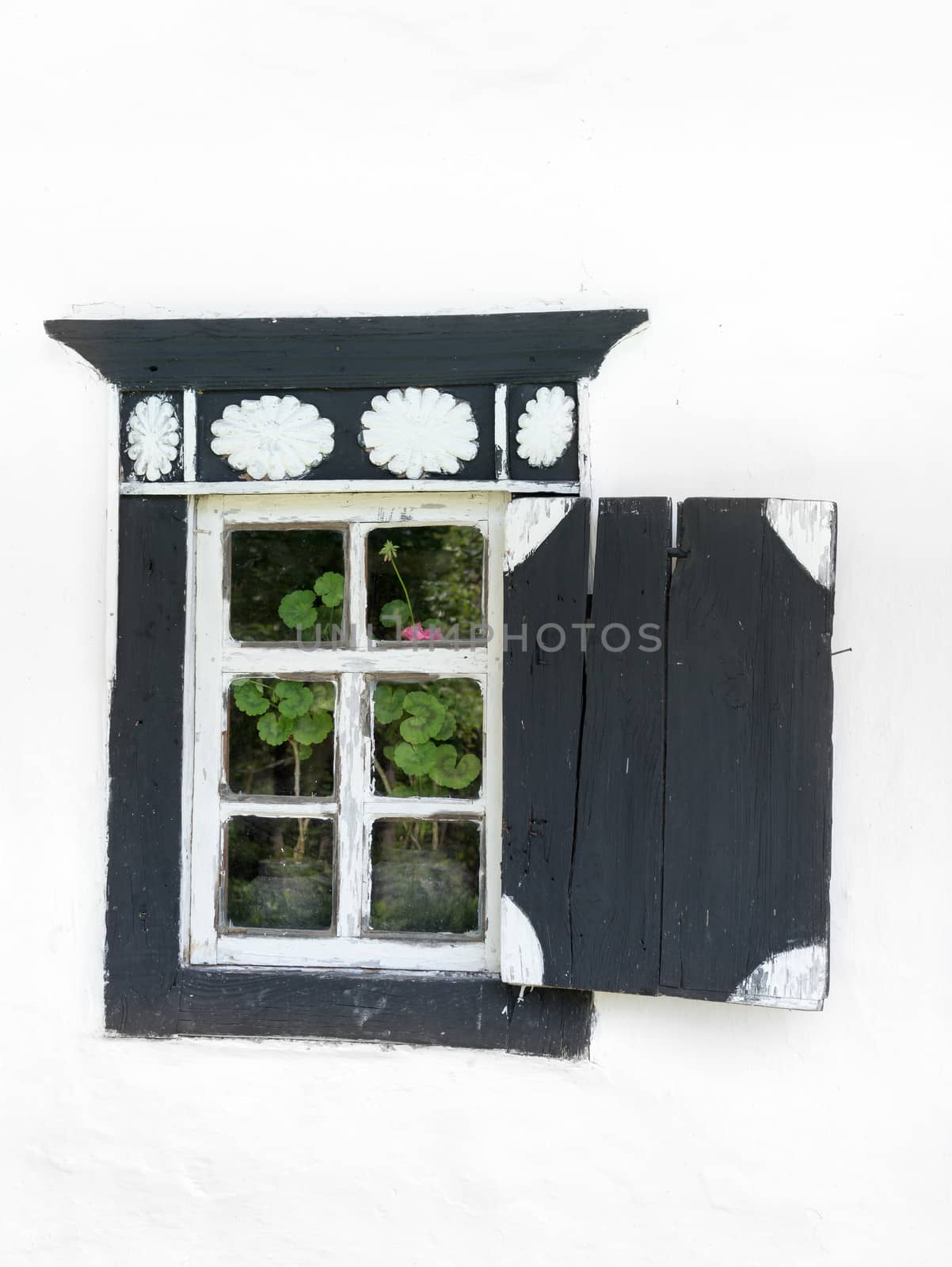 Old rustic window with door on a white wall