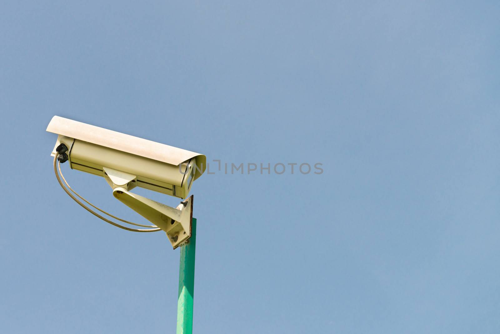 Security outdoor camera on blue sky background 