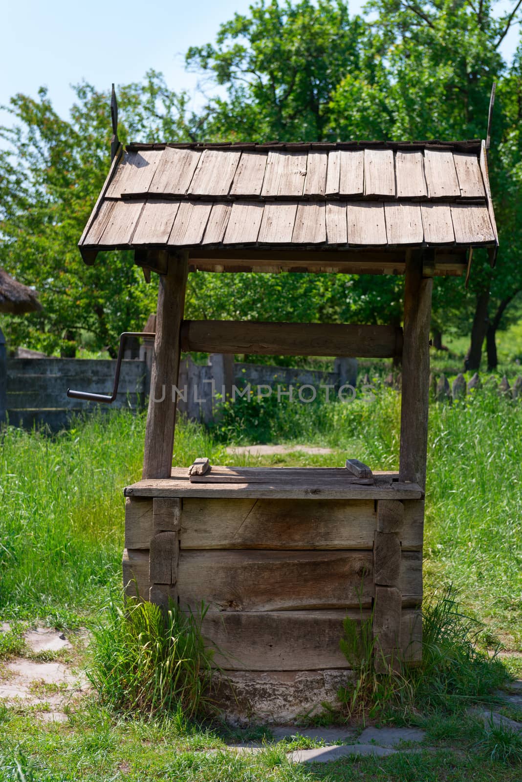 Old village well with a wood roof by iryna_rasko