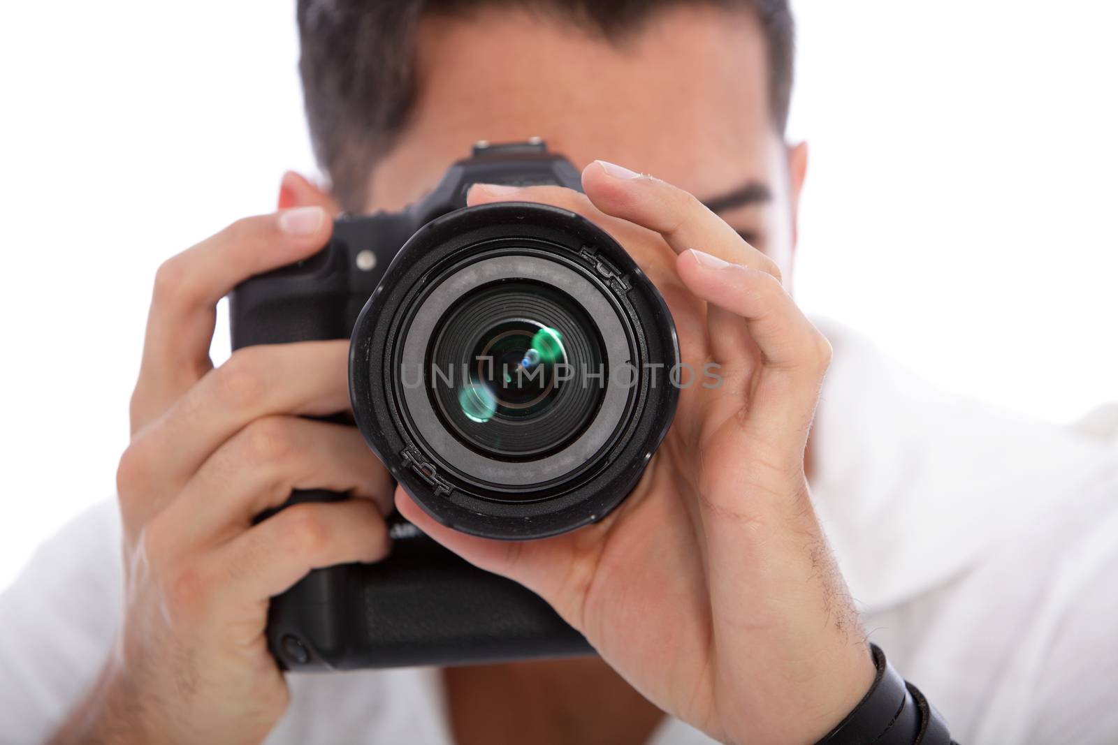 Male photographer taking a photograph focusing directly at the lens with his professional dslr camera