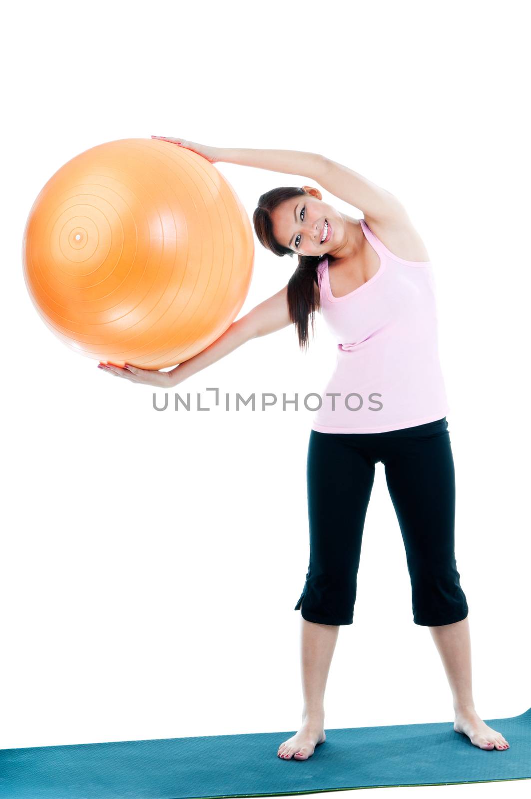 Full-length portrait of a cute young woman holding fitness ball