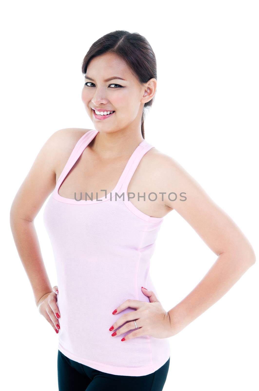 Portrait of a healthy woman with hands on hips over white background.