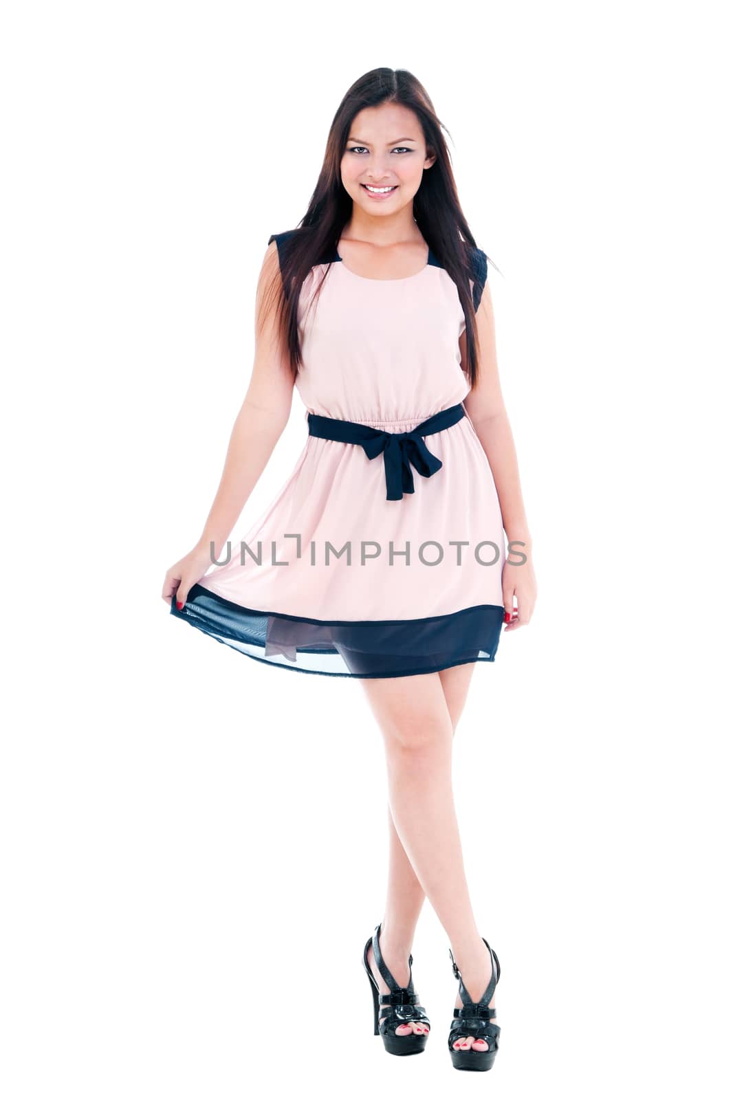 Full-length portrait of a stylish young Asian woman posing over white background.