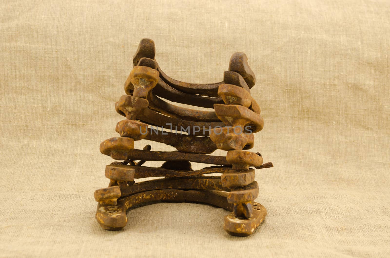 stack pile retro rusty horseshoes linen background by sauletas