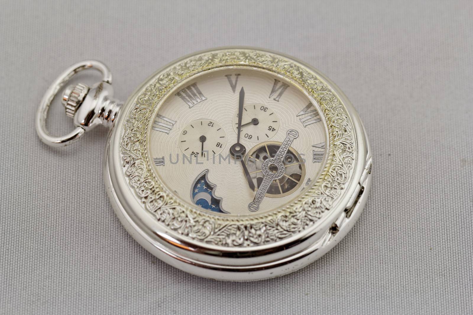 Part of a antique mechanical pocket watch on white background