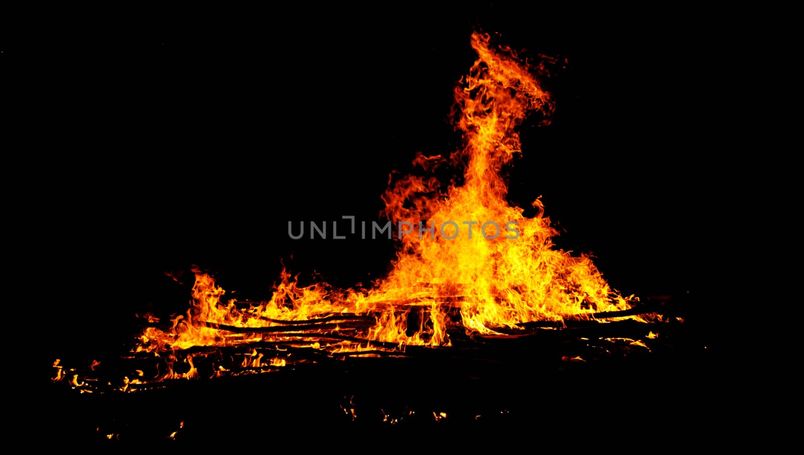 red flames of huge bonfire or campfire as black backgorund