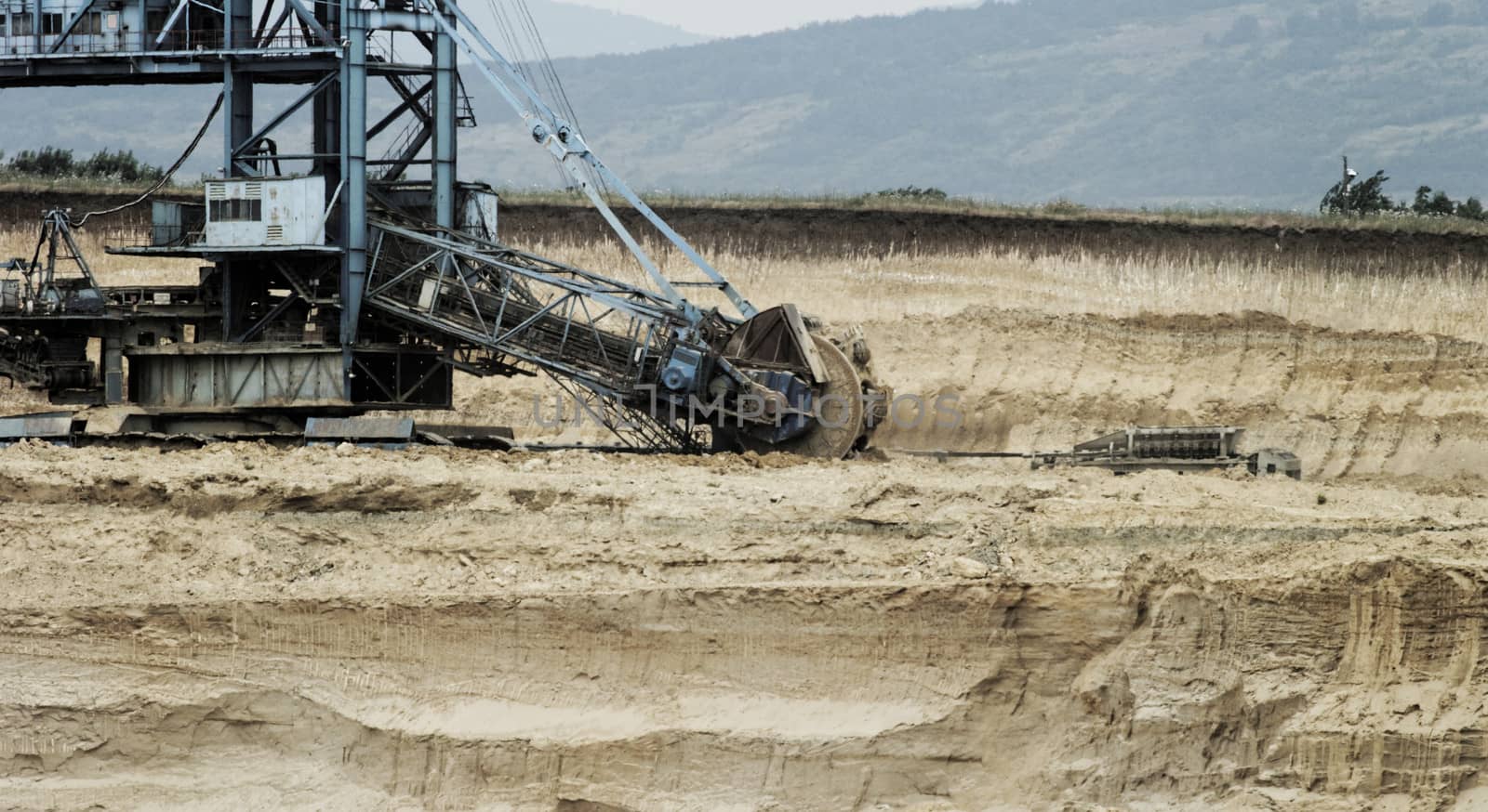 Coal mining in an open pit with huge industrial machine