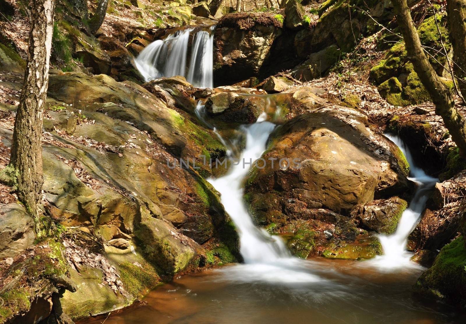 A small river flows through a wild landscape with rocks