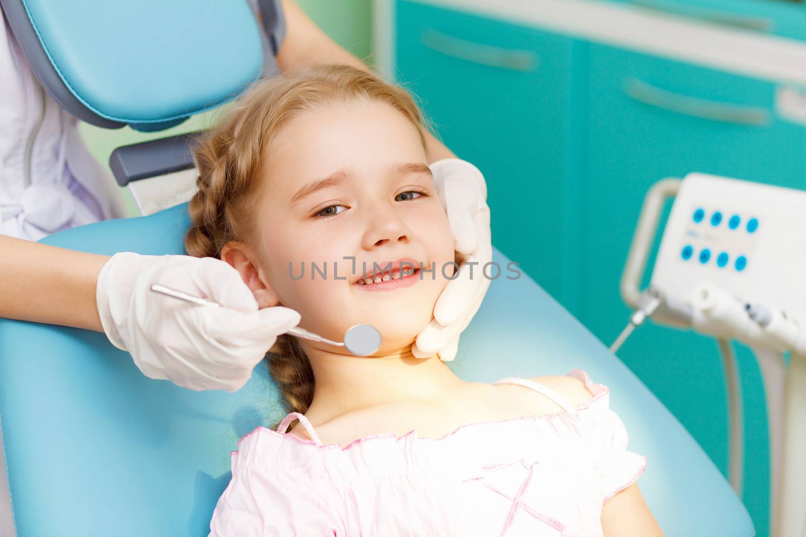 Little girl sitting in the dentists office