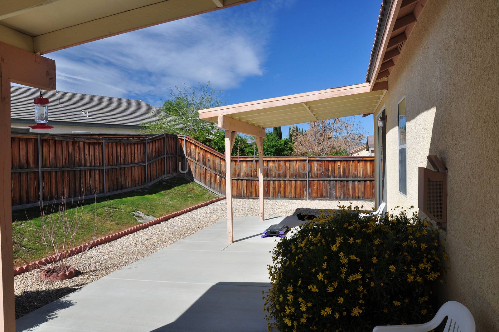 View of a backyard covered patio at a tract house in southern California.