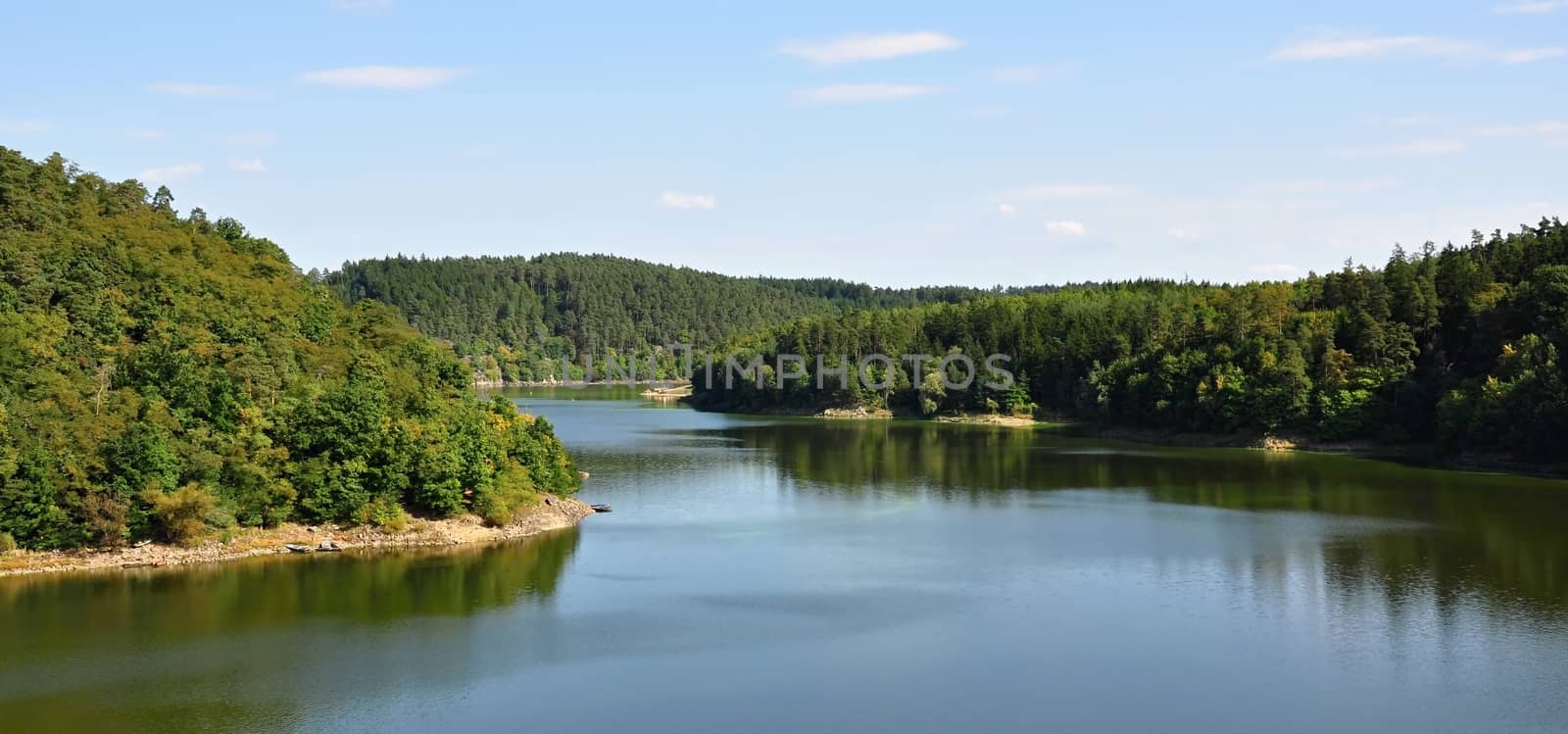 Dam in deep green forests and beautiful sandy beach