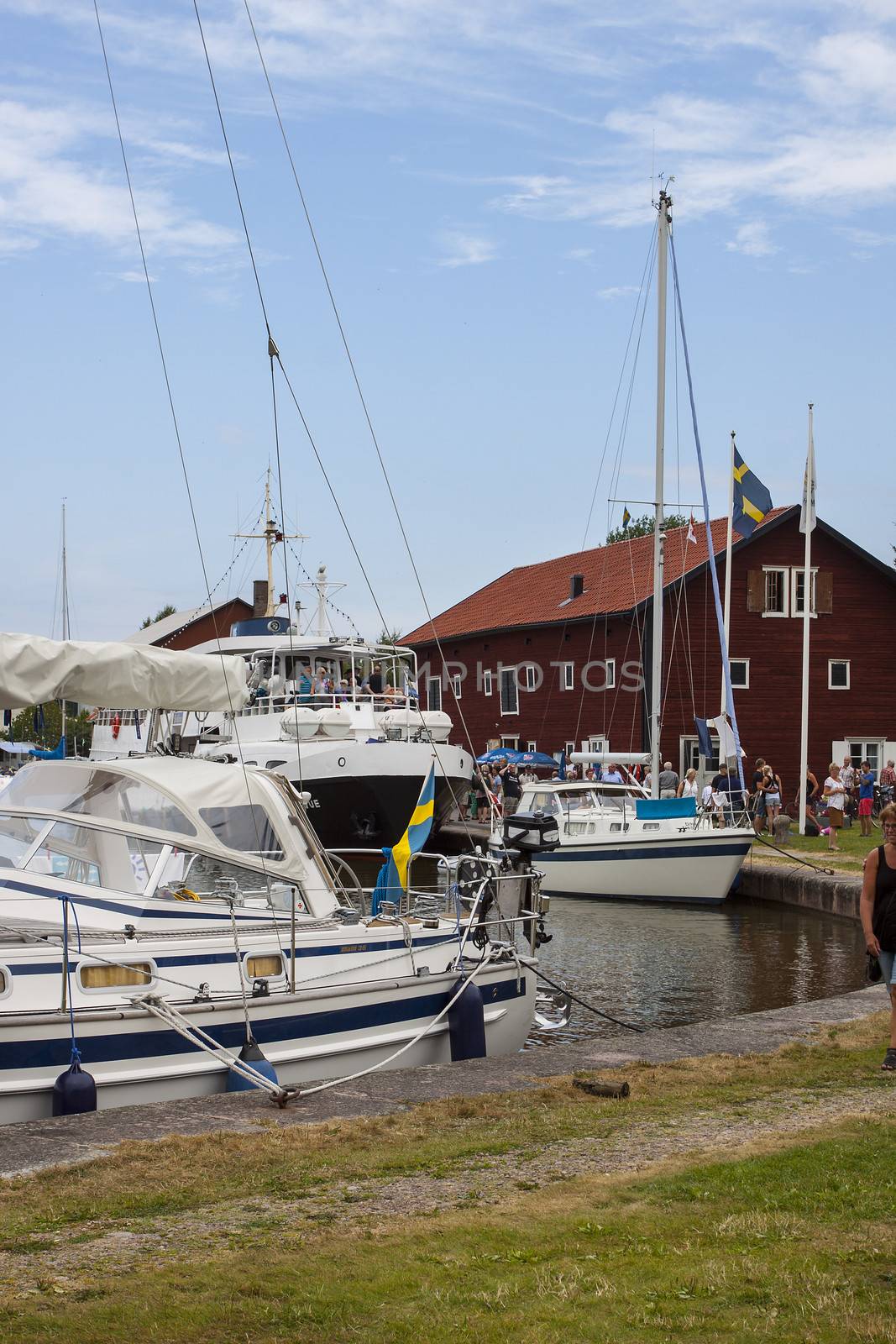 A harbor on the Gota Canal in Sweden with a passenger ship arriving for a stop