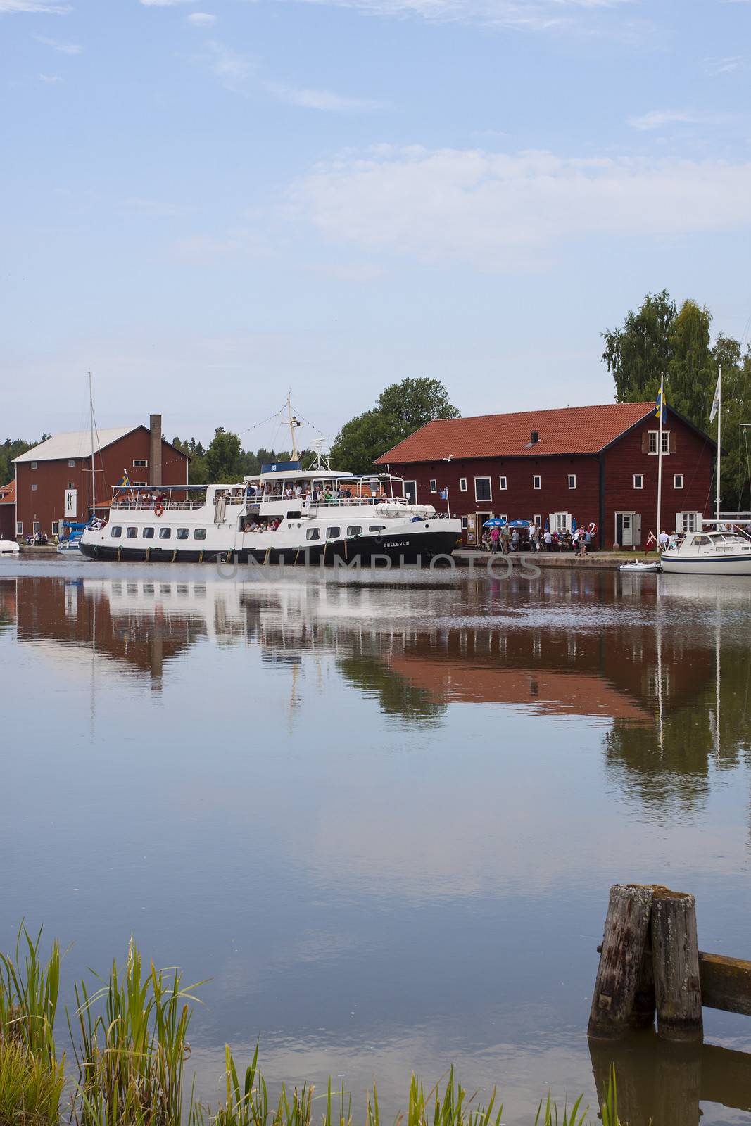 A harbor on the Gota Canal in Sweden with a passenger ship arriving for a stop