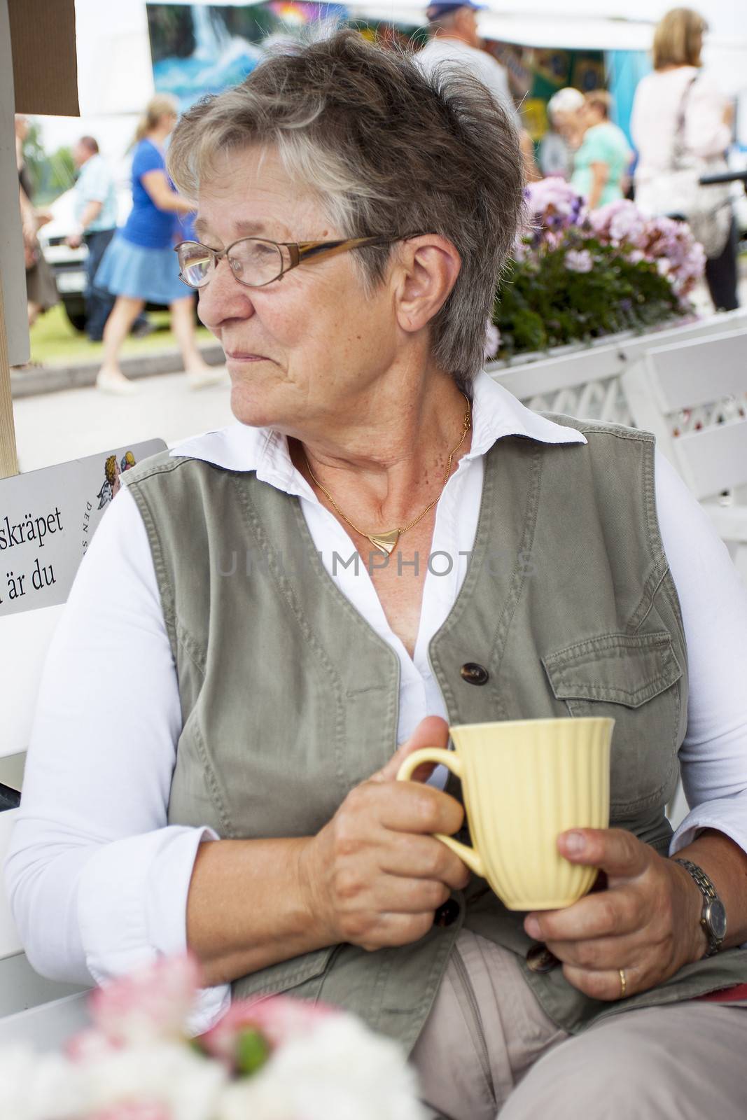 Old woman drinking coffee by annems