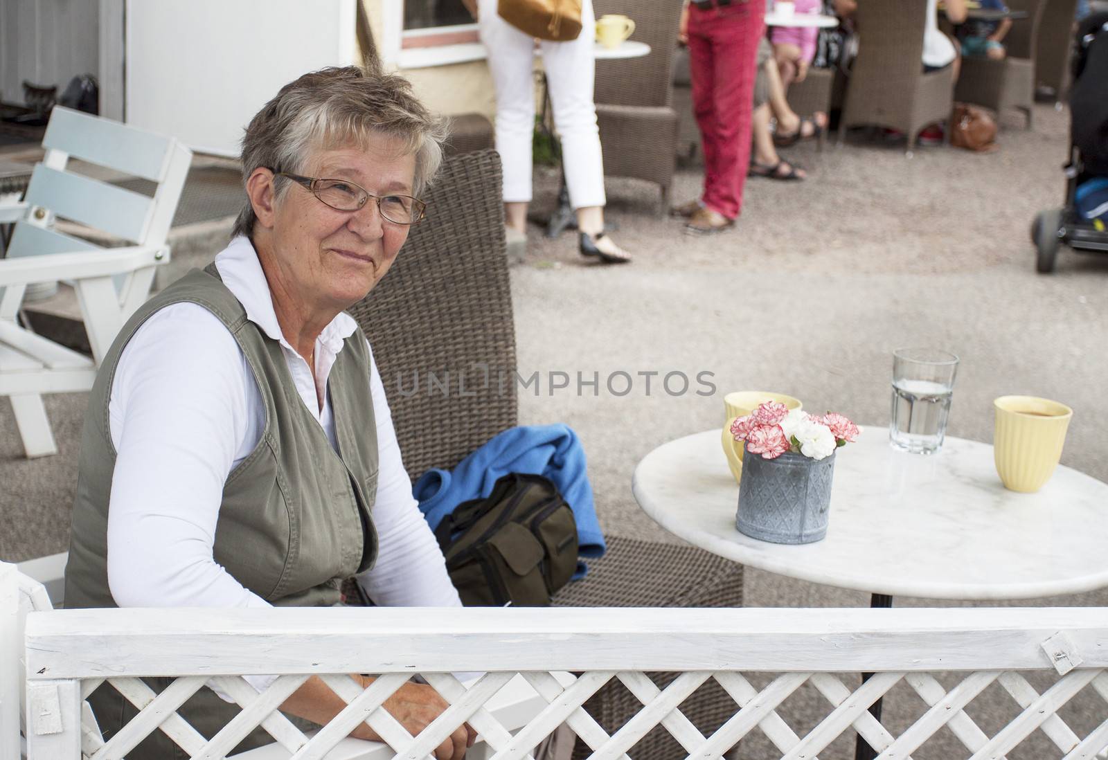 Old smiling woman in cafe by annems