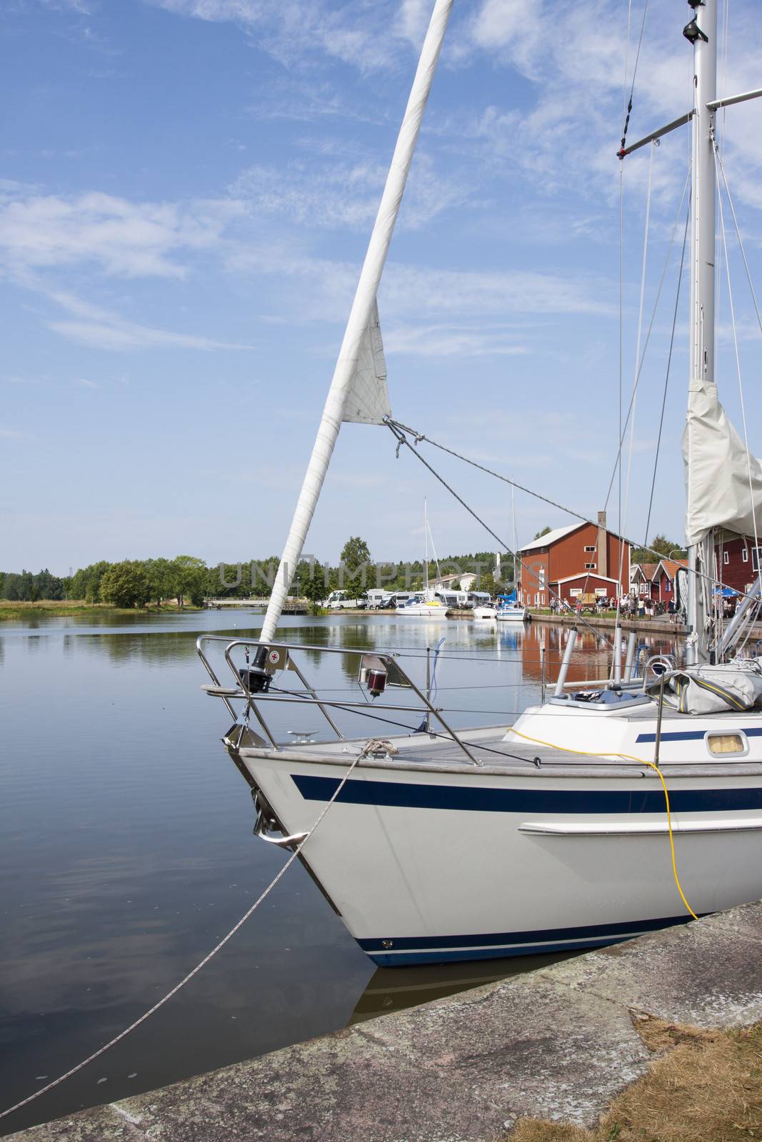 A harbor on the Gota Canal in Sweden with a yacht and other boats