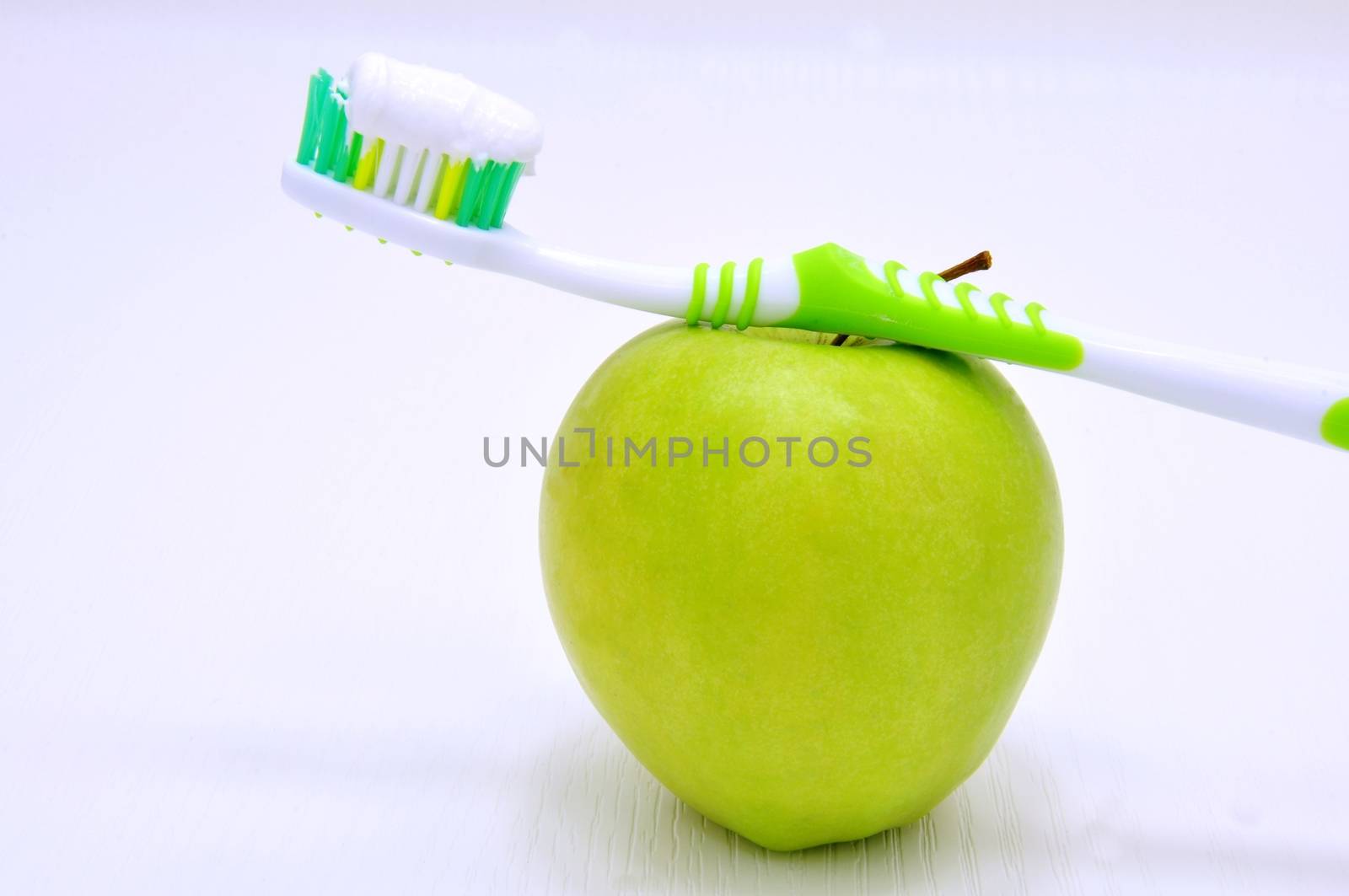 Green apple and toothbrush by ondrej83