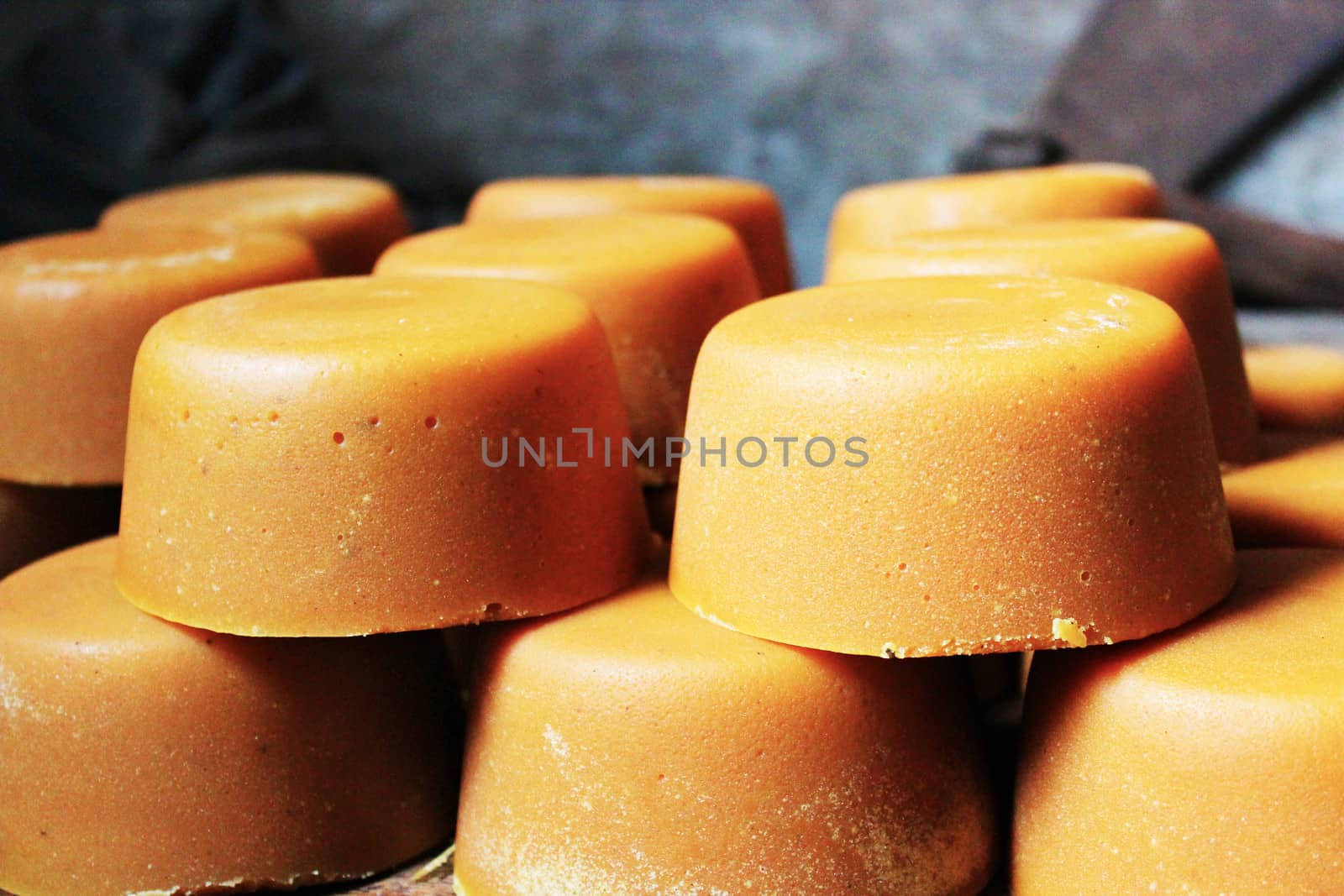 Gula merah or palm sugar blocks in a small artesanal factory in Java, Indonesia. The palm sugar is obtained from the sap of the coconut palm trees