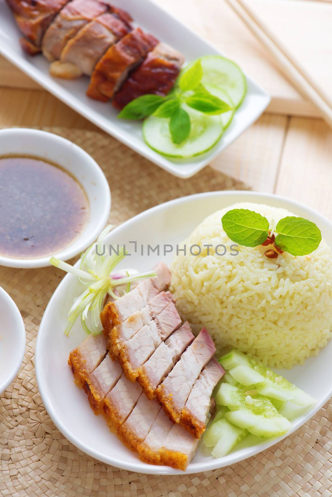 Siu Yuk or crispy roasted belly pork Chinese style and roast duck, served with steamed rice. Singapore Chinese cuisines.