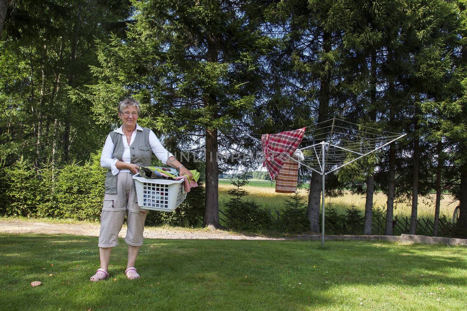 Old woman with laundry basket by annems