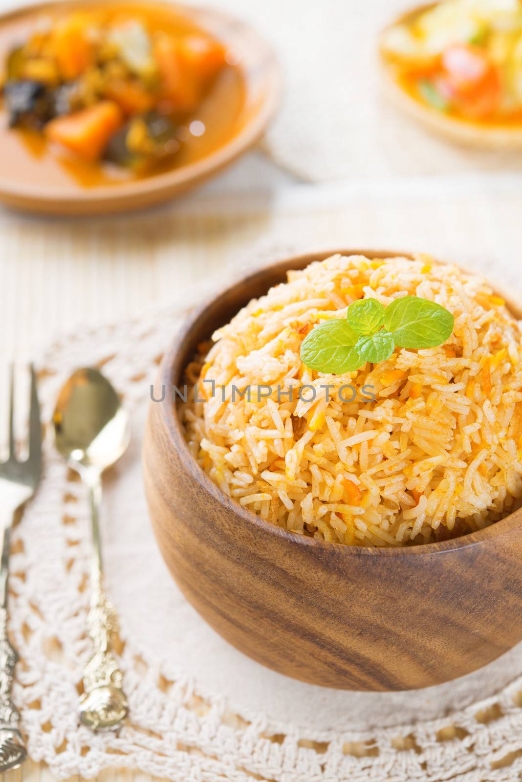 Indian vegetarian food. Biryani rice and curry dhal on dining table.