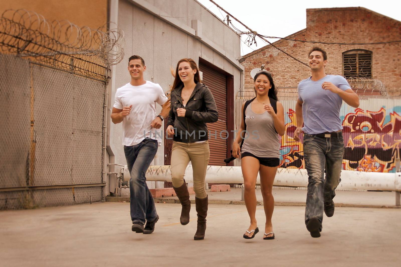 Group of friends running in urban environment.
