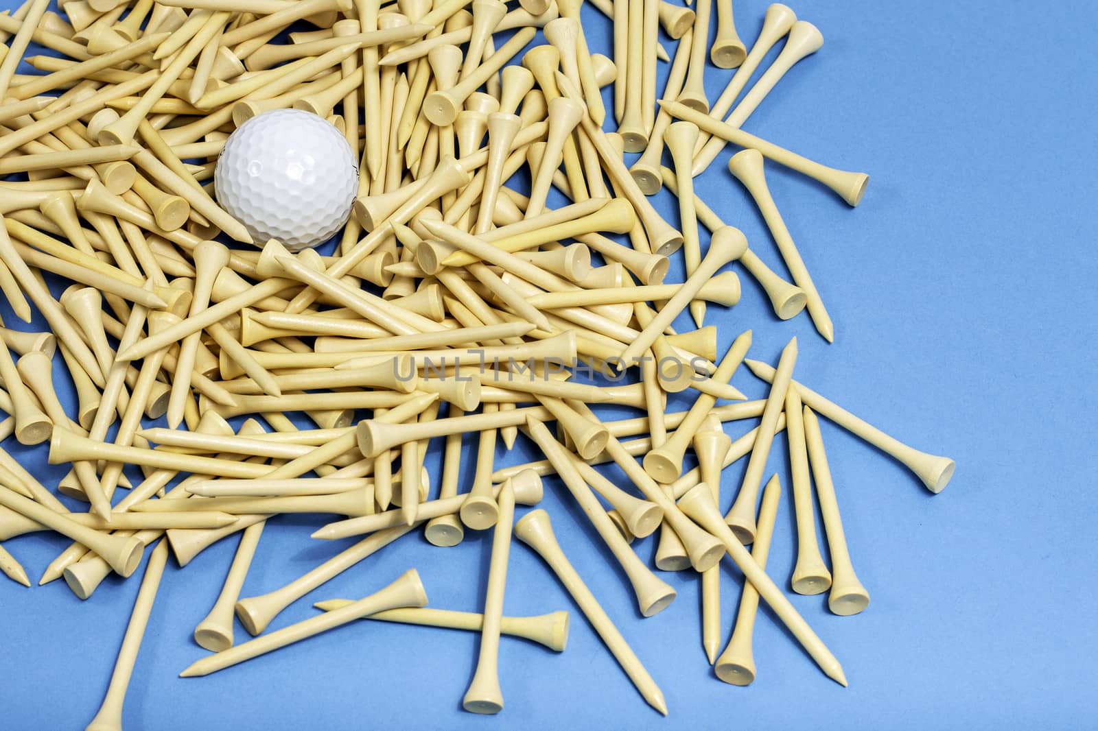 A bunch of golf tees on a blue background.