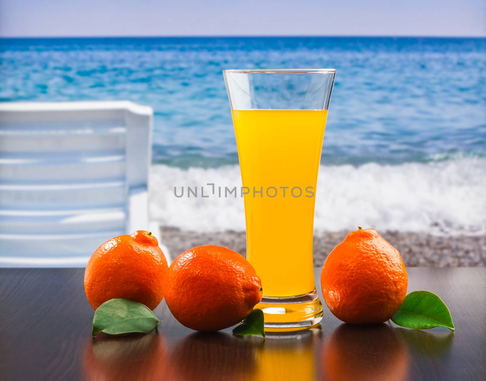 orange juice in a glass on a table by oleg_zhukov