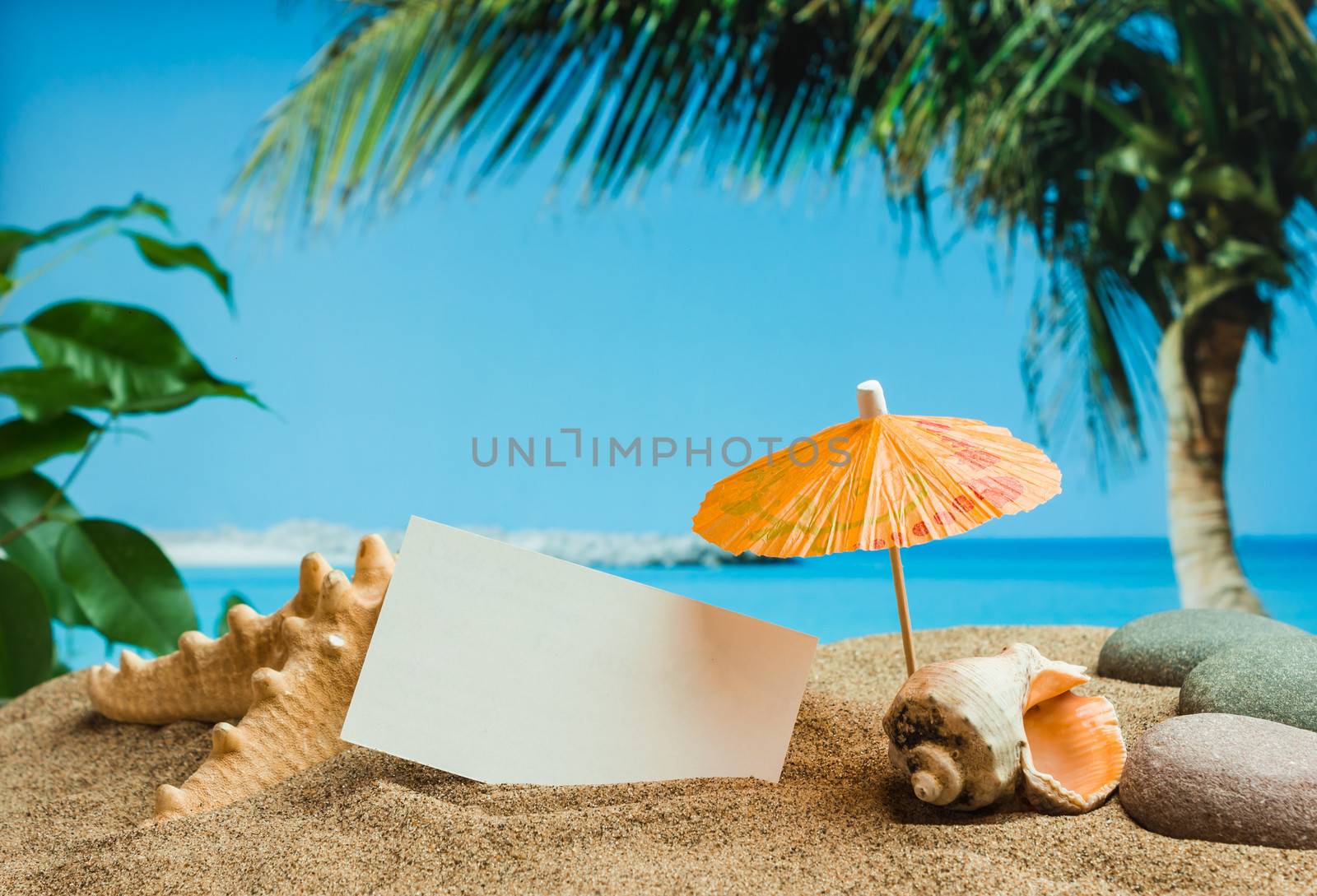 Umbrella on the sand on the background of the beach