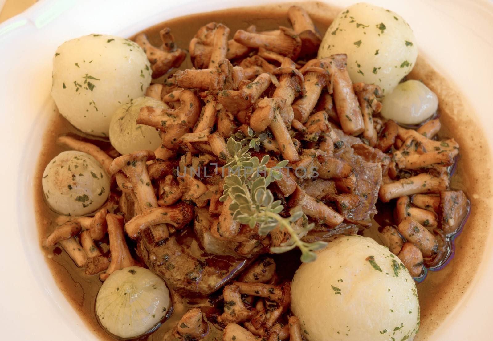 Beef casserole with mushrooms, onions and potatoes.