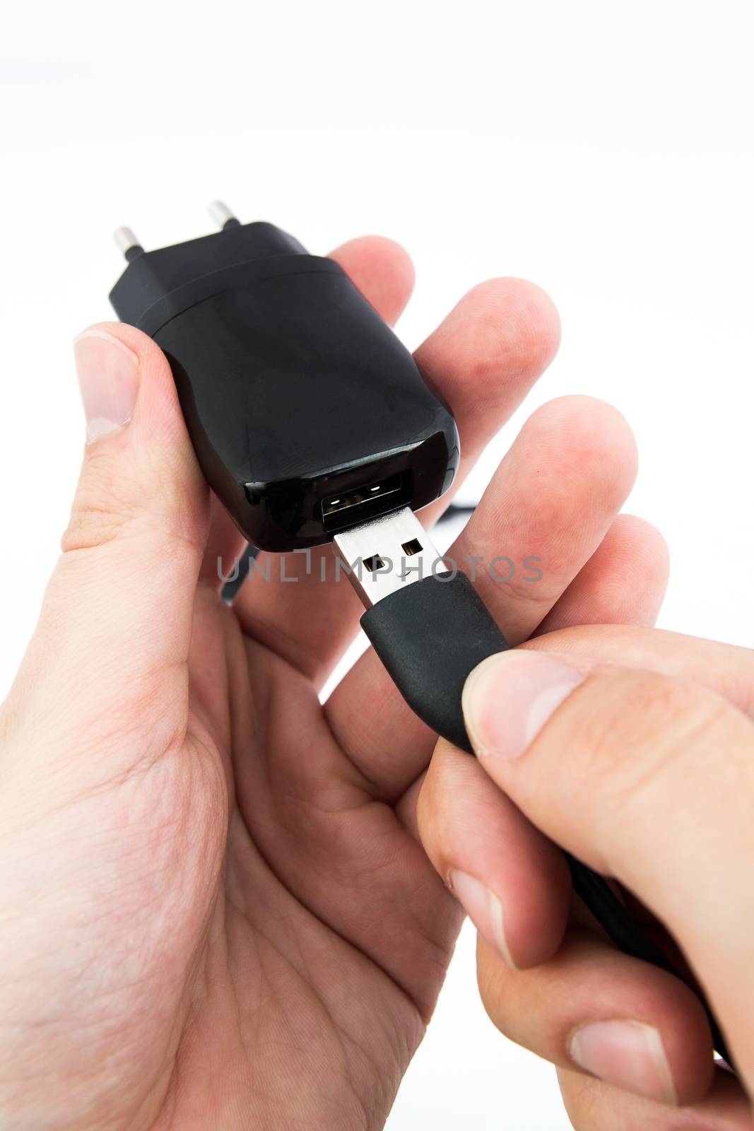 Man using black USB phone charger