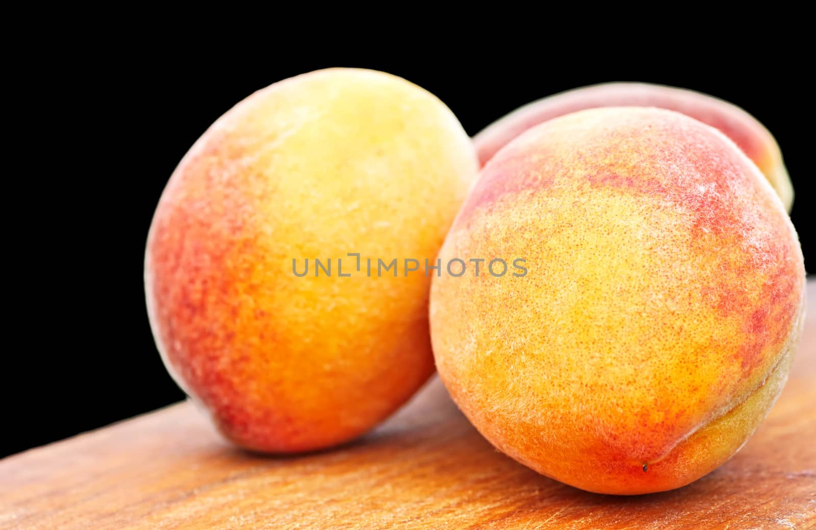 peaches on the table on a black background