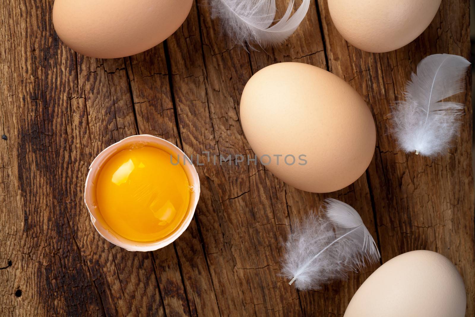 Fresh eggs on wood background. Top view