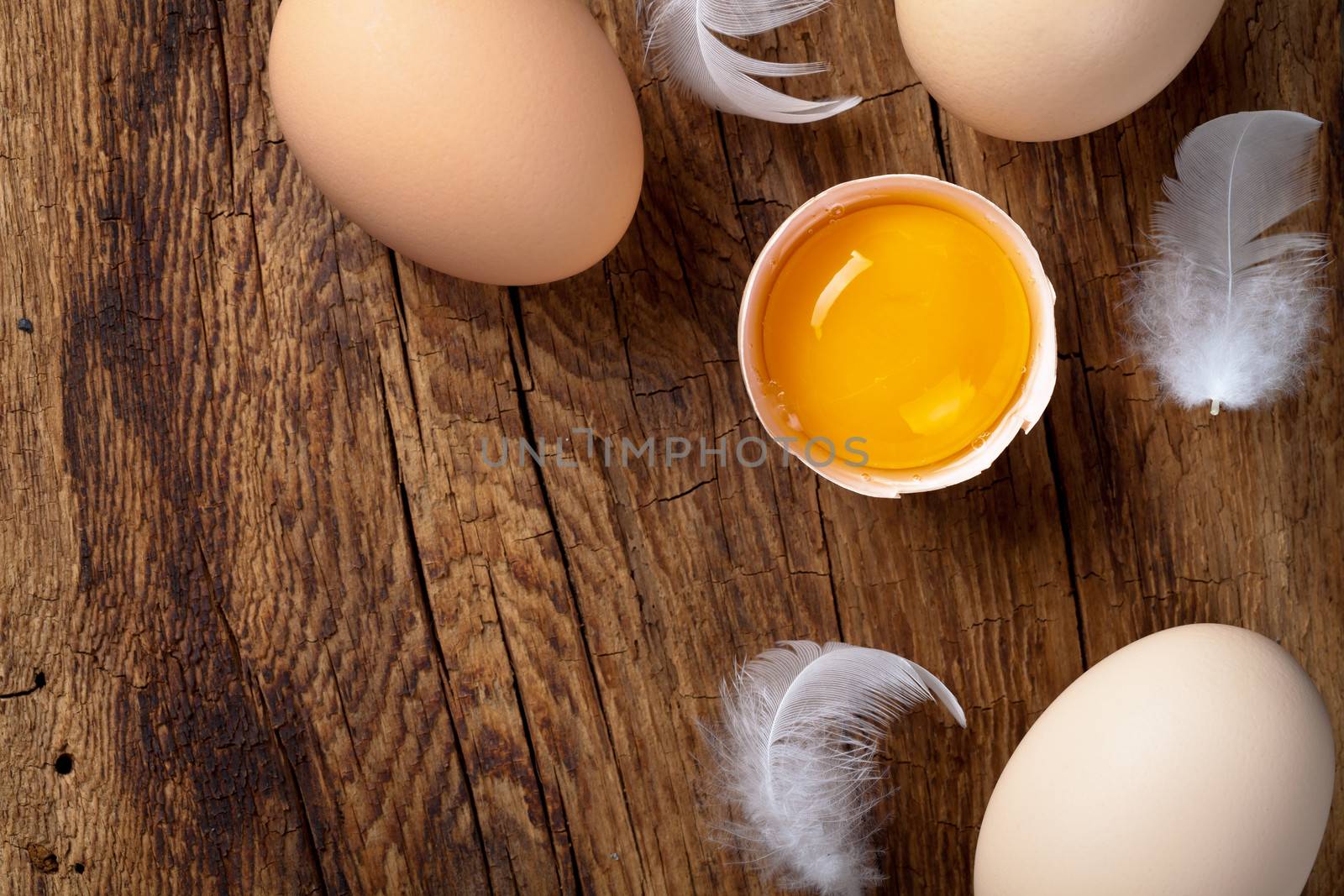 Fresh eggs on wood background. Copy space. Top view

