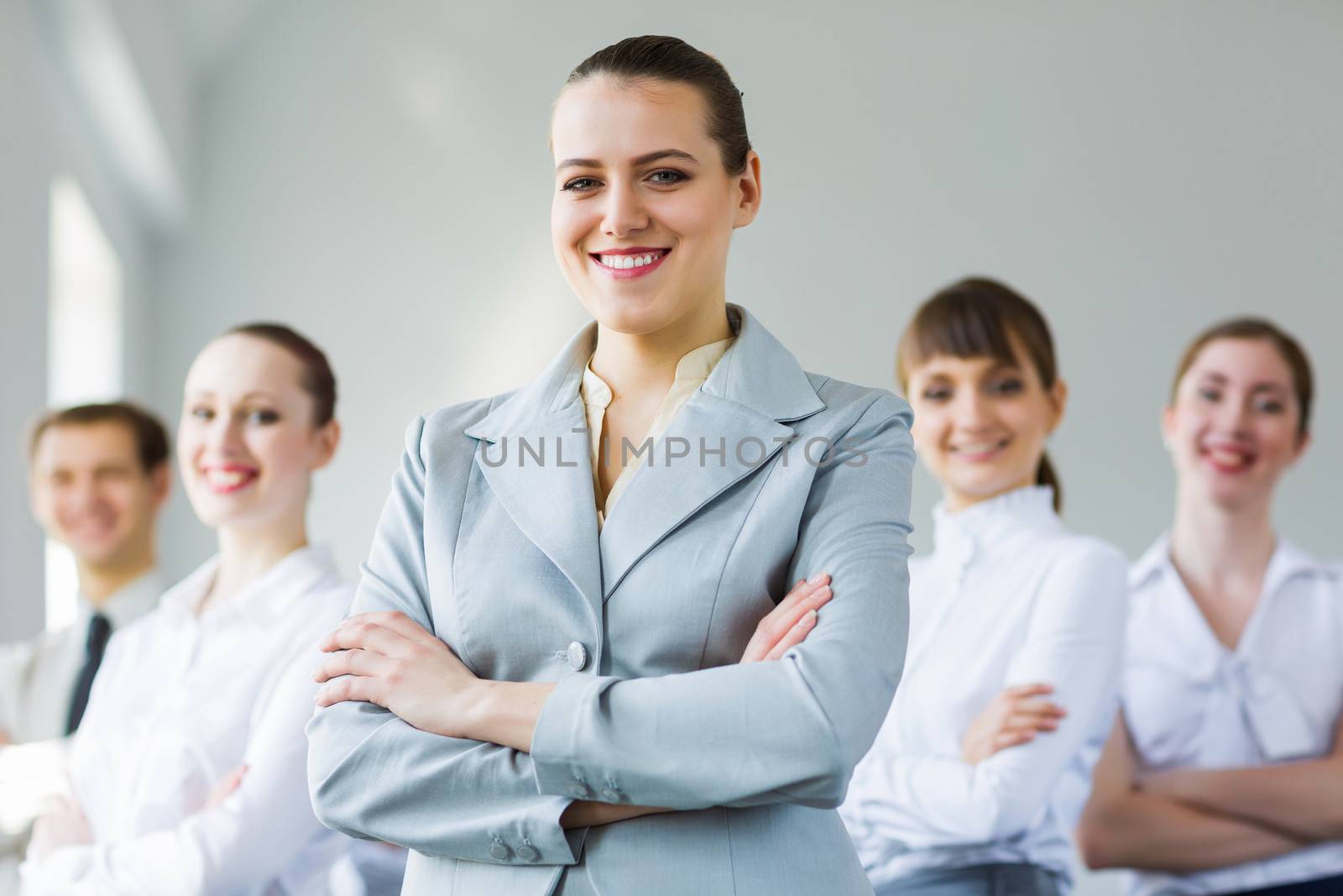 Young smiling businesswoman with colleagues. Leadership concept