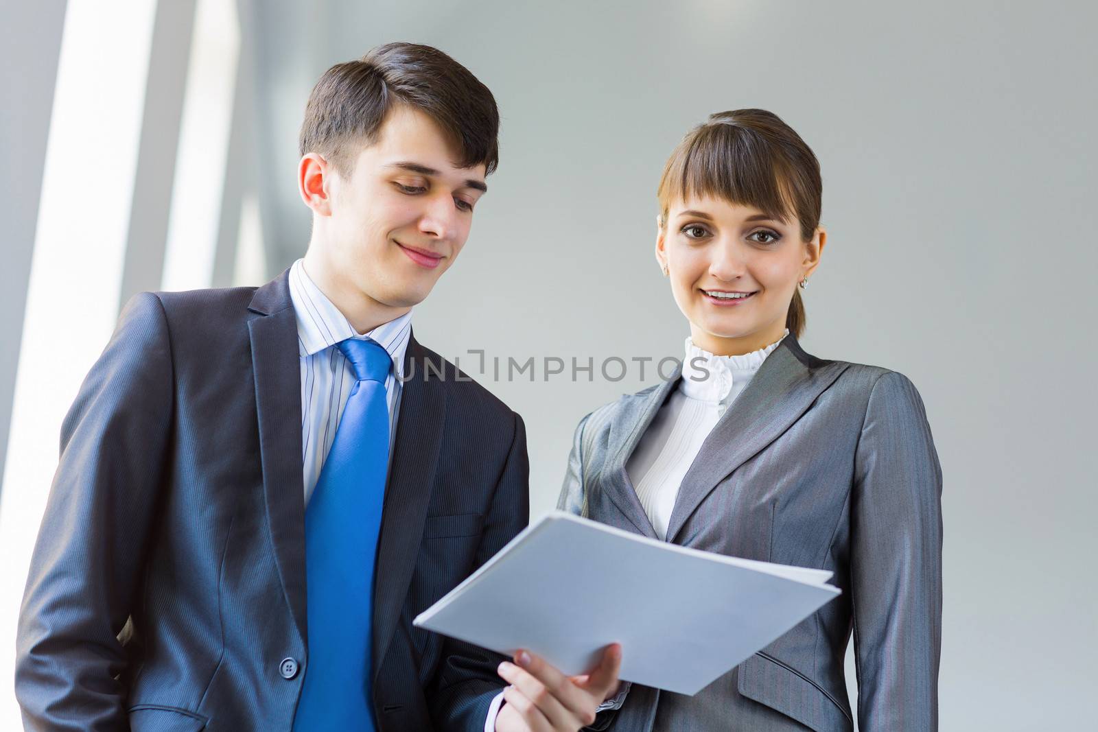 Young happy businessman and businesswoman people discussing project