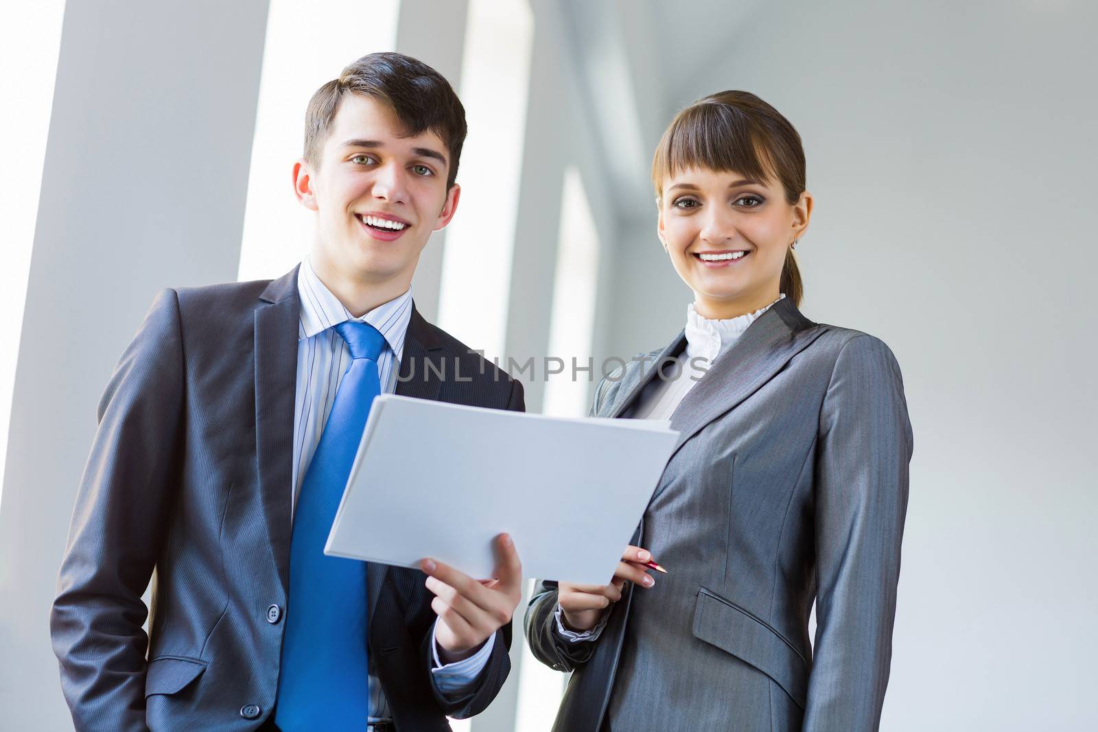 Young happy businessman and businesswoman people discussing project