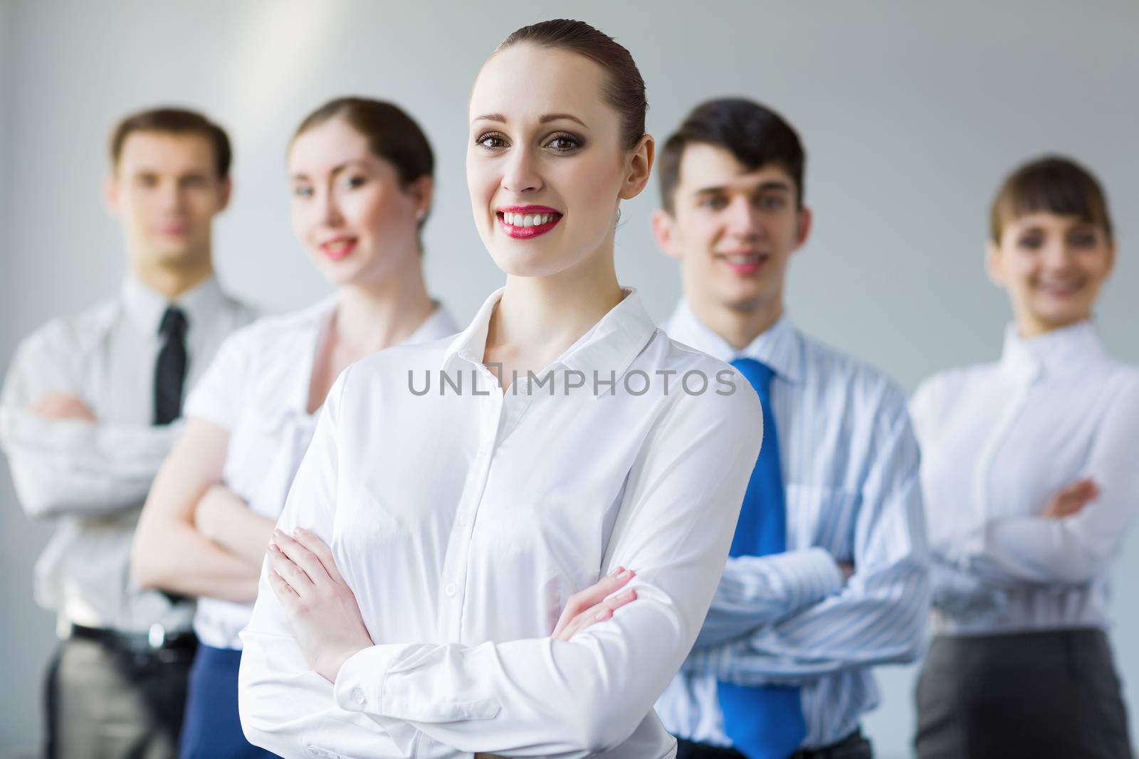 Young smiling businesswoman with colleagues. Leadership concept