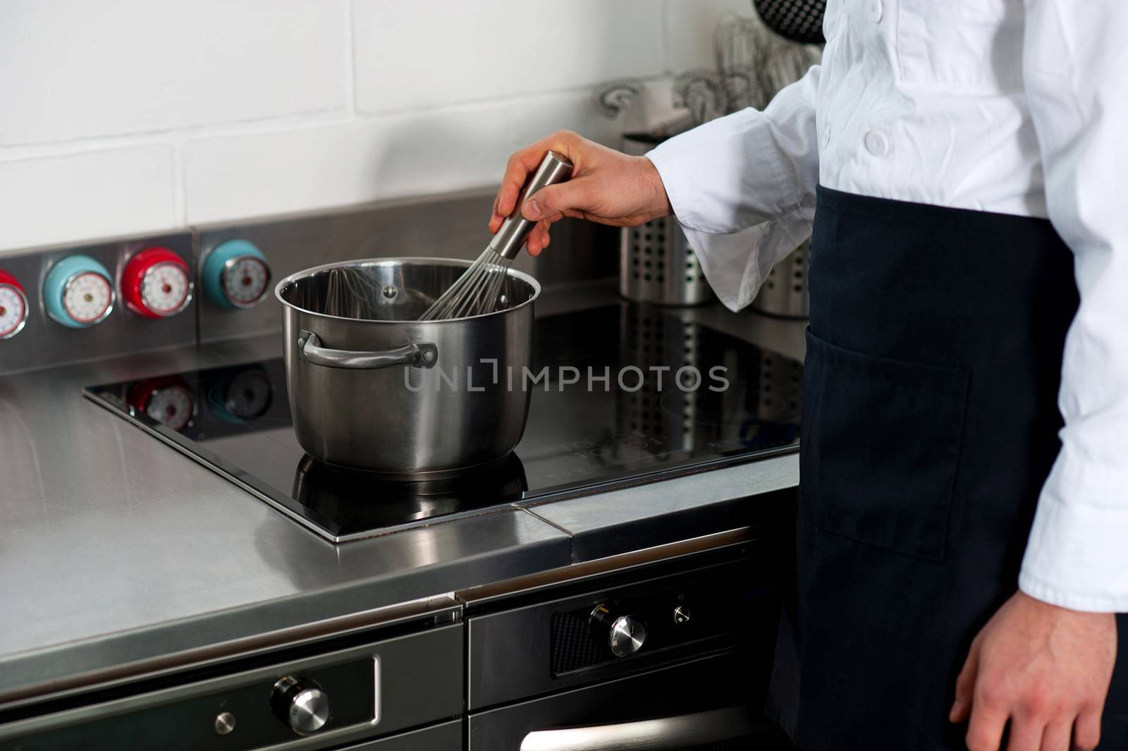 Chef in restaurant kitchen by stockyimages