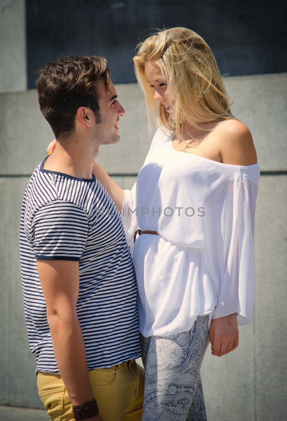 Romantic couple looking in each other's eyes smiling by artofphoto